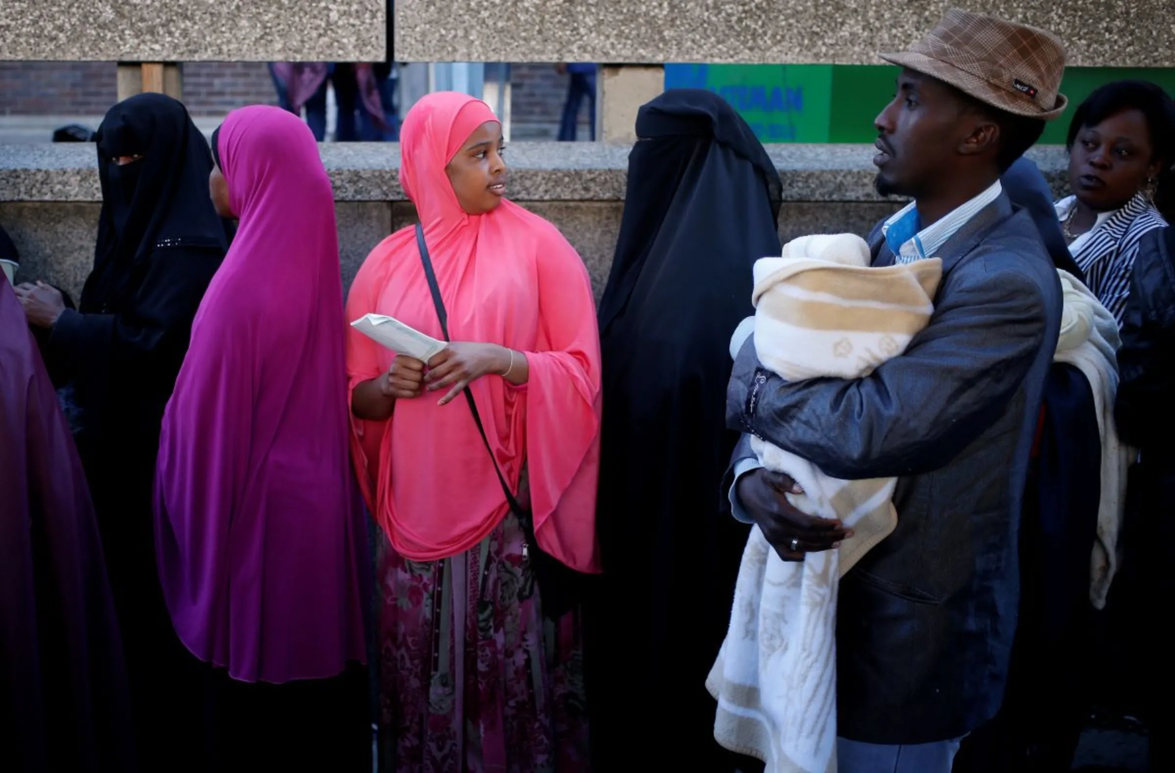 Asylum seekers queue to get their documents renewed outside a Department of Home Affairs reception centre in Cape Town May 29, 2013. REUTERS/Mike Hutchings