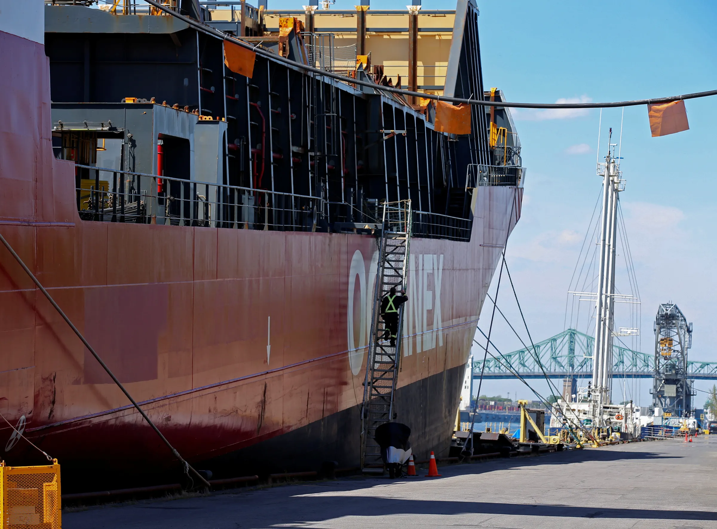 A crew member boards a cargo ship in the Port of Montreal in Montreal, Quebec, Canada, May 17, 2021. REUTERS/Christinne Muschi