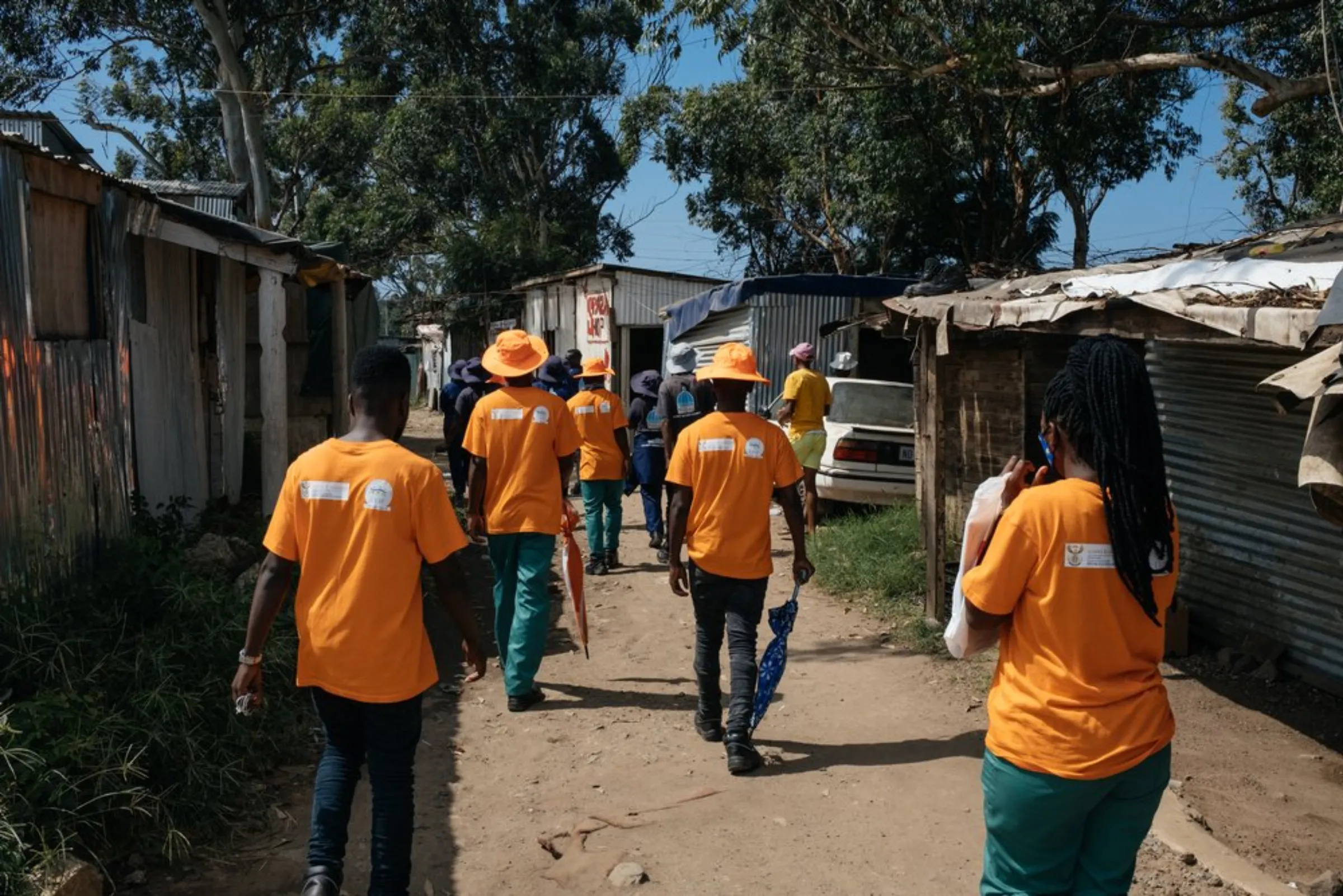 Members of the Enviro Champs initiative take part in a patrol through the Quarry Road informal settlement in Durban, South Africa, March 30, 2021. The initiative employs locals from vulnerable communities, creating job opportunities and helping them be better prepared in the face of climate change impacts such as flooding and extreme weather