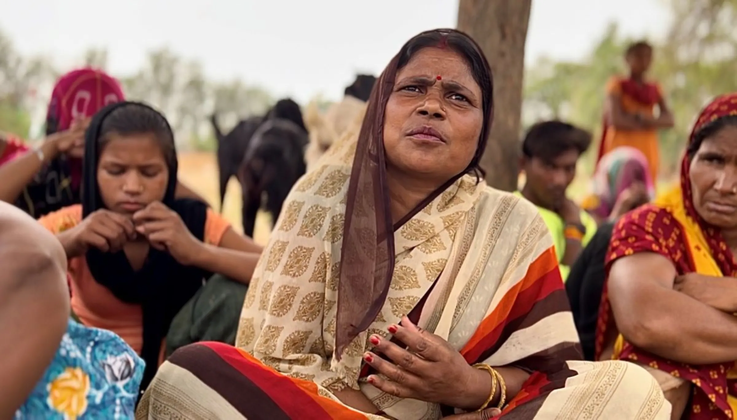 Housewife Vandana sits with other women in a village in Banda, India, May 15, 2024. Thomson Reuters Foundation/Bhasker Tripathi