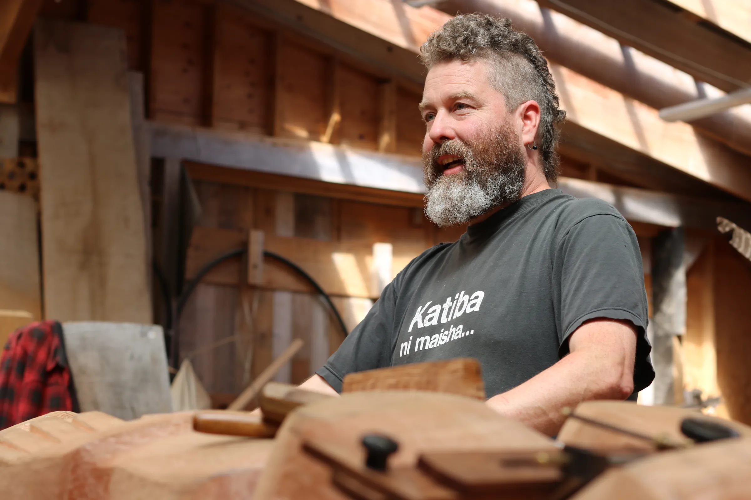 Gwaai Edenshaw, a traditional carver in Haida Gwaii, carves a totem pole in honour of his father Guujaaw, on Graham Island, Canada. July 23, 2024. Thomson Reuters Foundation/Jack Graham