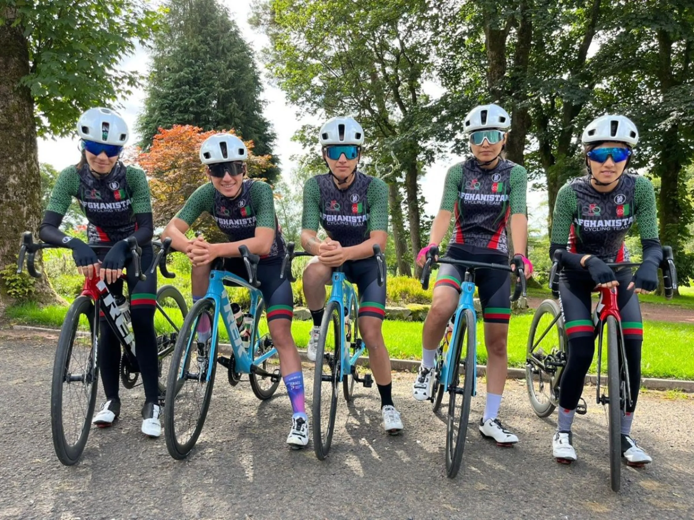 The Hashimi sisters (2L and centre) are pictured with other Afghan cyclists at the
UCI Cycling World Championships in Glasgow, Scotland in 2023. Afghanistan Cycling Federation/Handout via Thomson Reuters Foundation