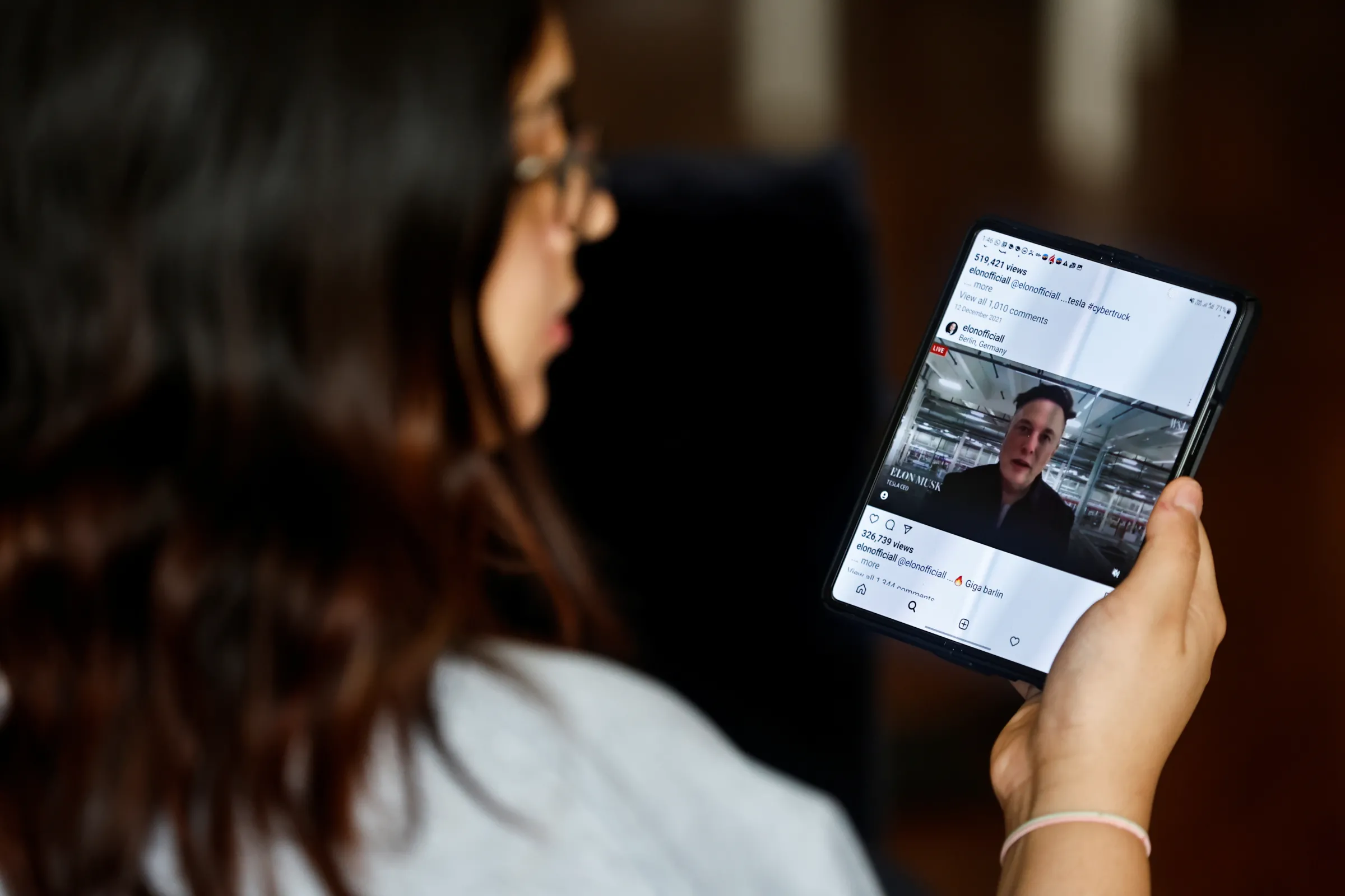 A blogger and social media specialist, Hera Shabbir checks her social media accounts on her smart phone in Manama, Bahrain, April 28, 2022