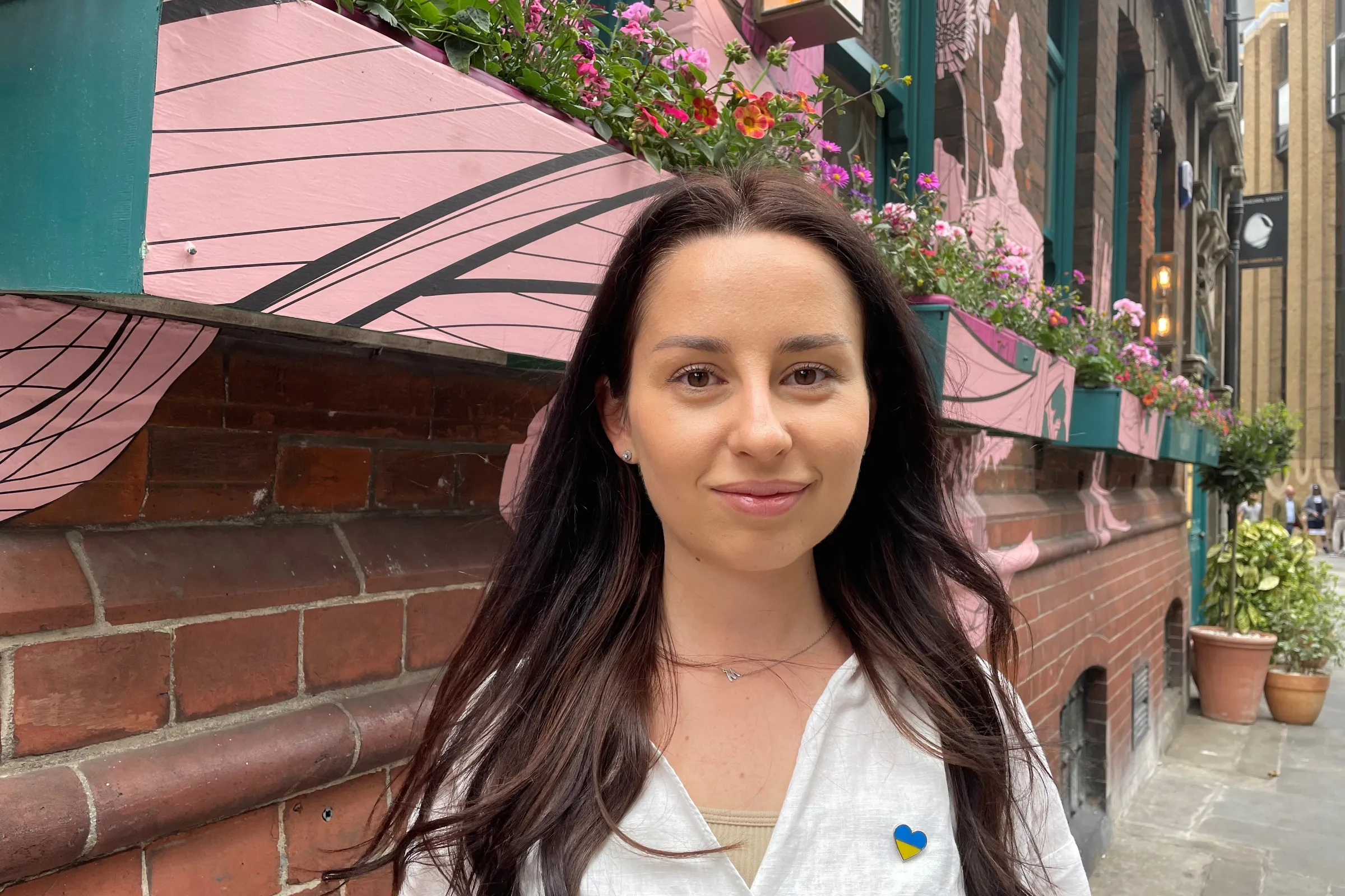 Margaryta Bogatyrova, 27, stands outside Mallow restaurant in Borough Market, London, where she works as a waitress after fleeing her home in Ukraine's eastern Donbas region, July 9, 2022. Thomson Reuters Foundation/Emma Batha