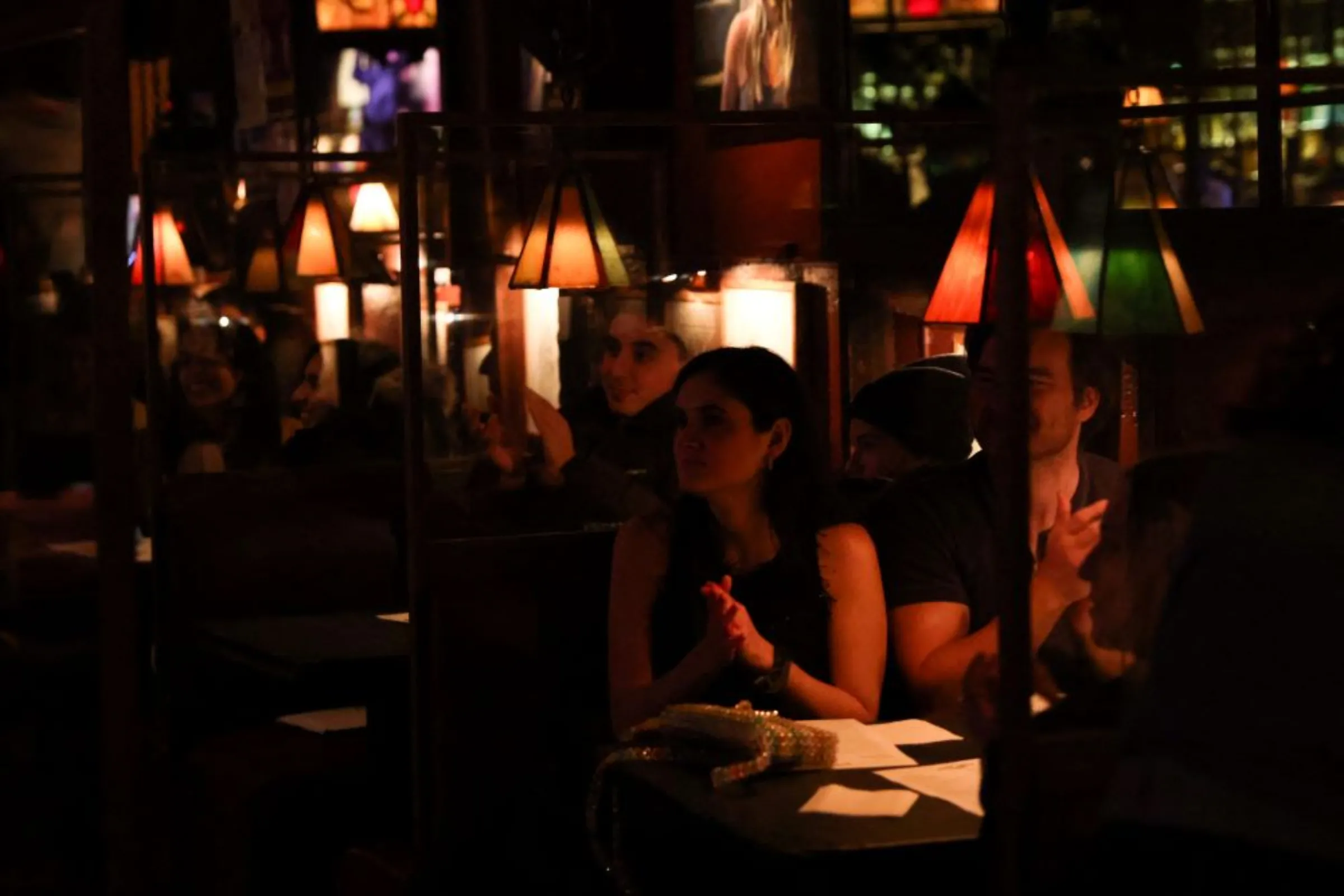 People watch a performance at Comedy Club on its first night back open after loosened restrictions during the continued outbreak of the coronavirus disease (COVID-19) in Manhattan, New York, U.S., April 2, 2021