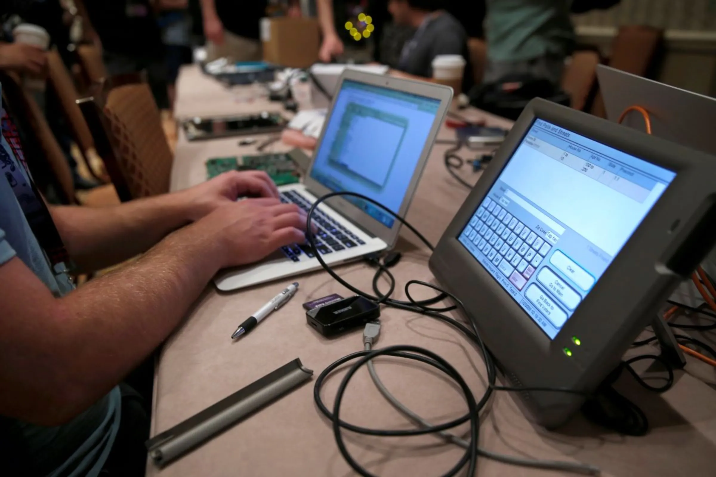 A hacker tries to access and alter data from an electronic poll book in a Voting Machine Hacking Village during the Def Con hacker convention in Las Vegas, Nevada, U.S. on July 29, 2017. REUTERS/Steve Marcus