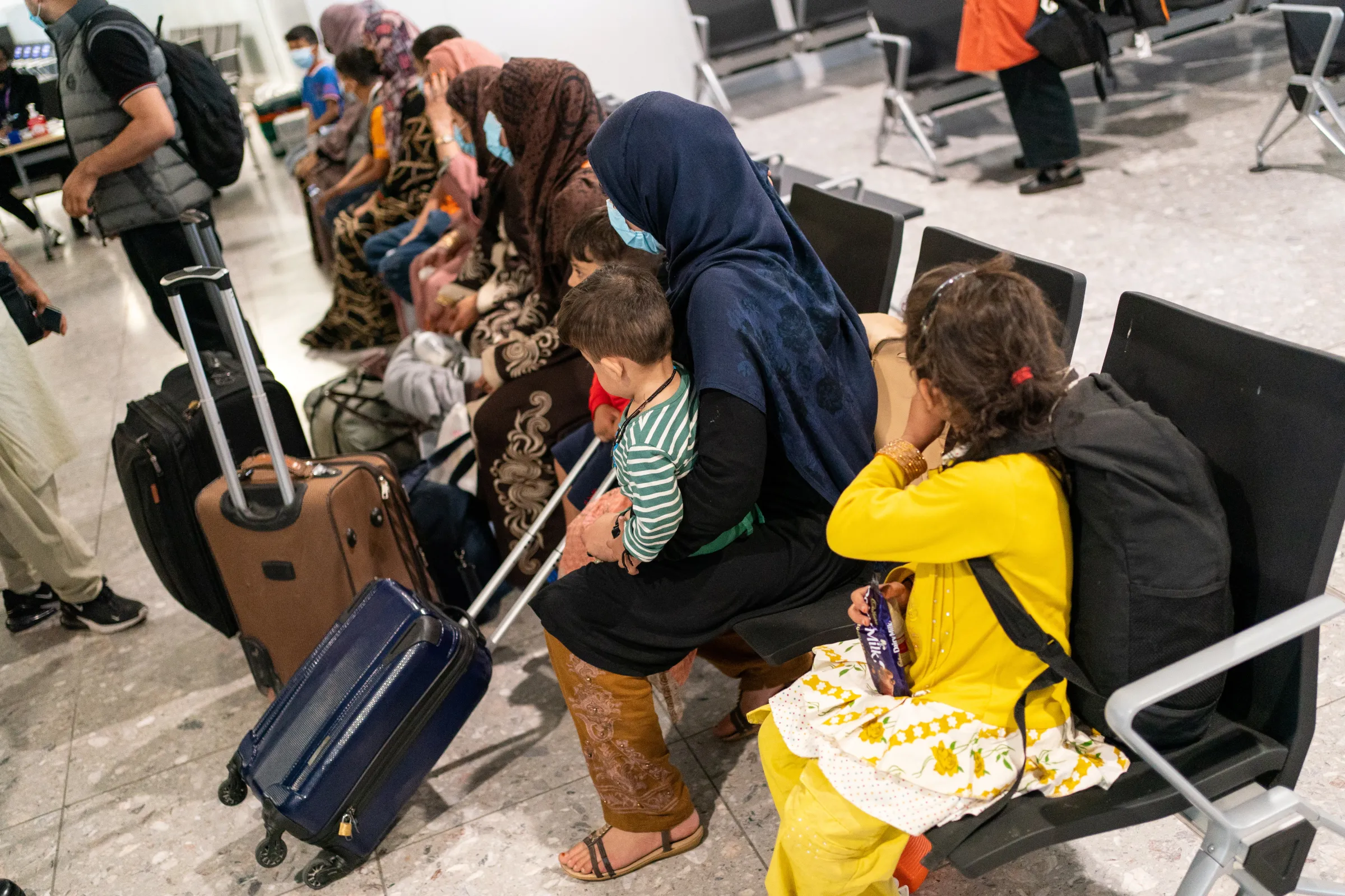 Refugees from Afghanistan wait to be processed after arriving on an evacuation flight at Heathrow Airport, in London, Britain August 26, 2021. Dominic Lipinski/Pool via REUTERS