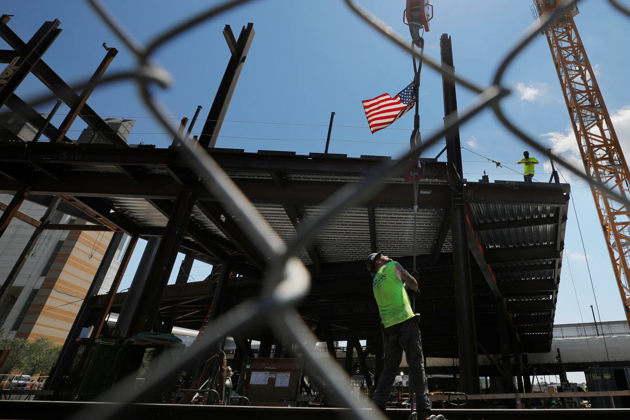 Members of the Ironworkers Local 7 union install steel beams on high-rise building under construction during a summer heat wave in Boston, Massachusetts, U.S., June 30, 2021. REUTERS/Brian Snyder