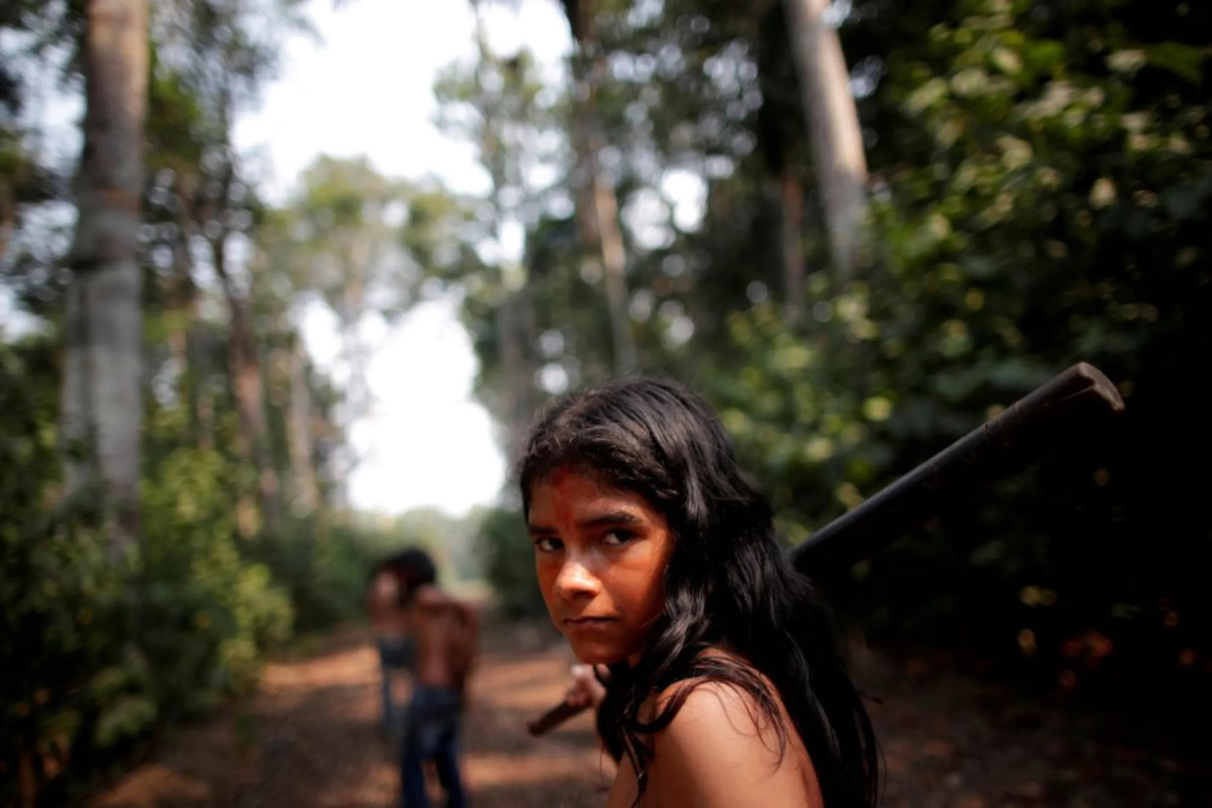 A boy from the Indigenous Mura tribe, reacts in front of a deforested area in nondemarcated indigenous land inside the Amazon rainforest, near Humaita, Amazonas State, Brazil, August 20, 2019. REUTERS/Ueslei Marcelino