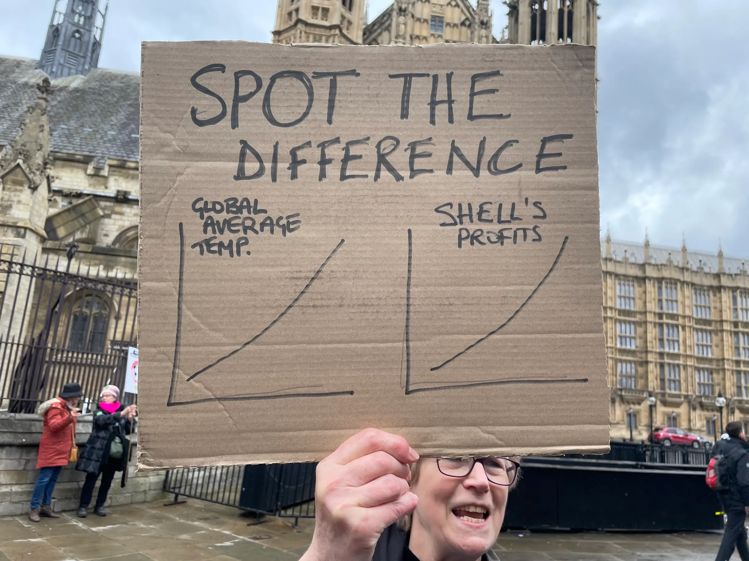 A climate change activist holds a sign at “The Big One”, a protest organised by Extinction Rebellion outside Parliament in London on April 21, 2023. Thomson Reuters Foundation/Laurie Goering