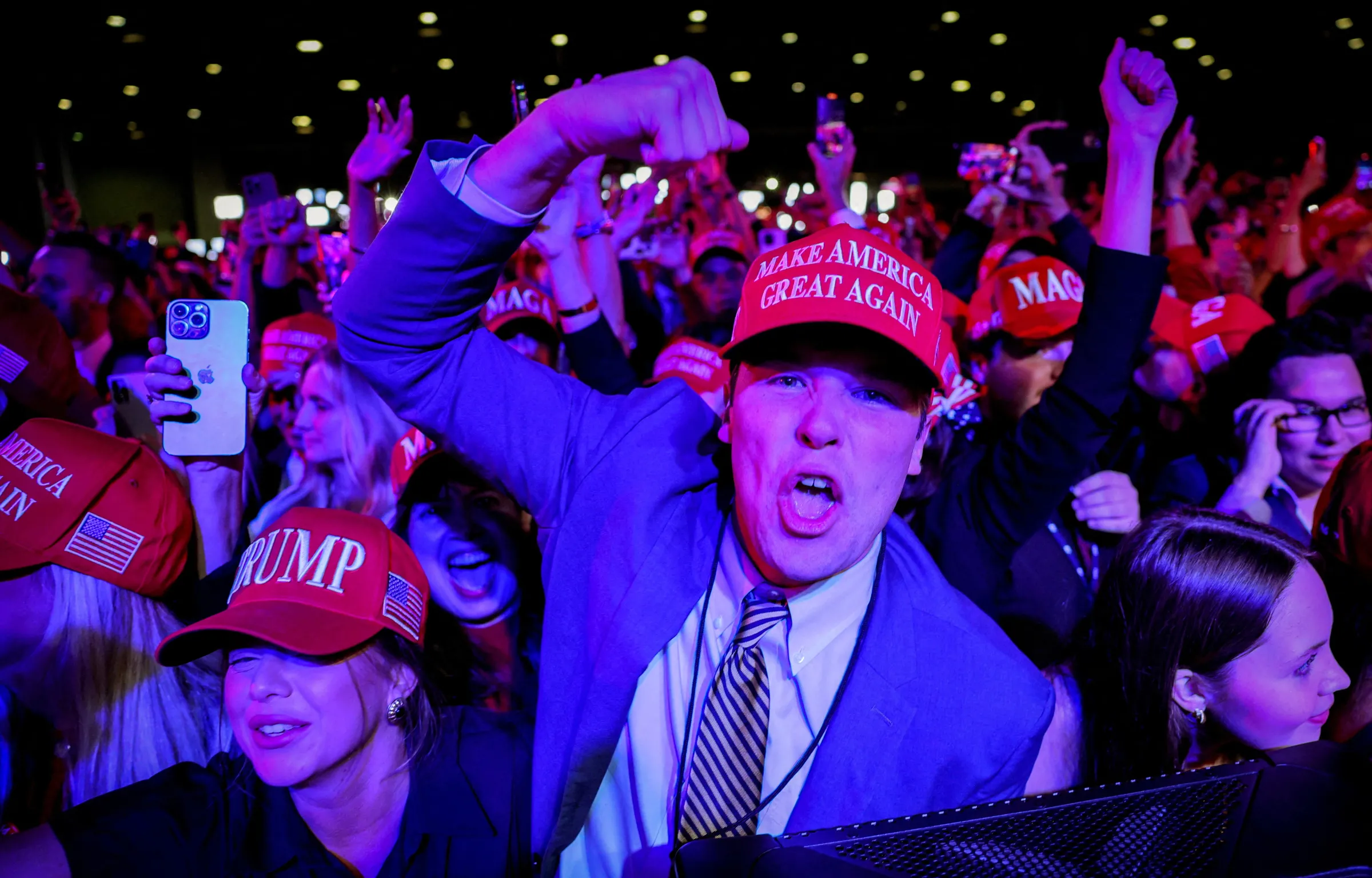 Supporters of Republican presidential nominee and former U.S. President Donald Trump celebrate after the Fox Network called the election in his favor at the site of his rally, at the Palm Beach County Convention Center in West Palm Beach, Florida, U.S., November 6, 2024. REUTERS/Brian Snyder