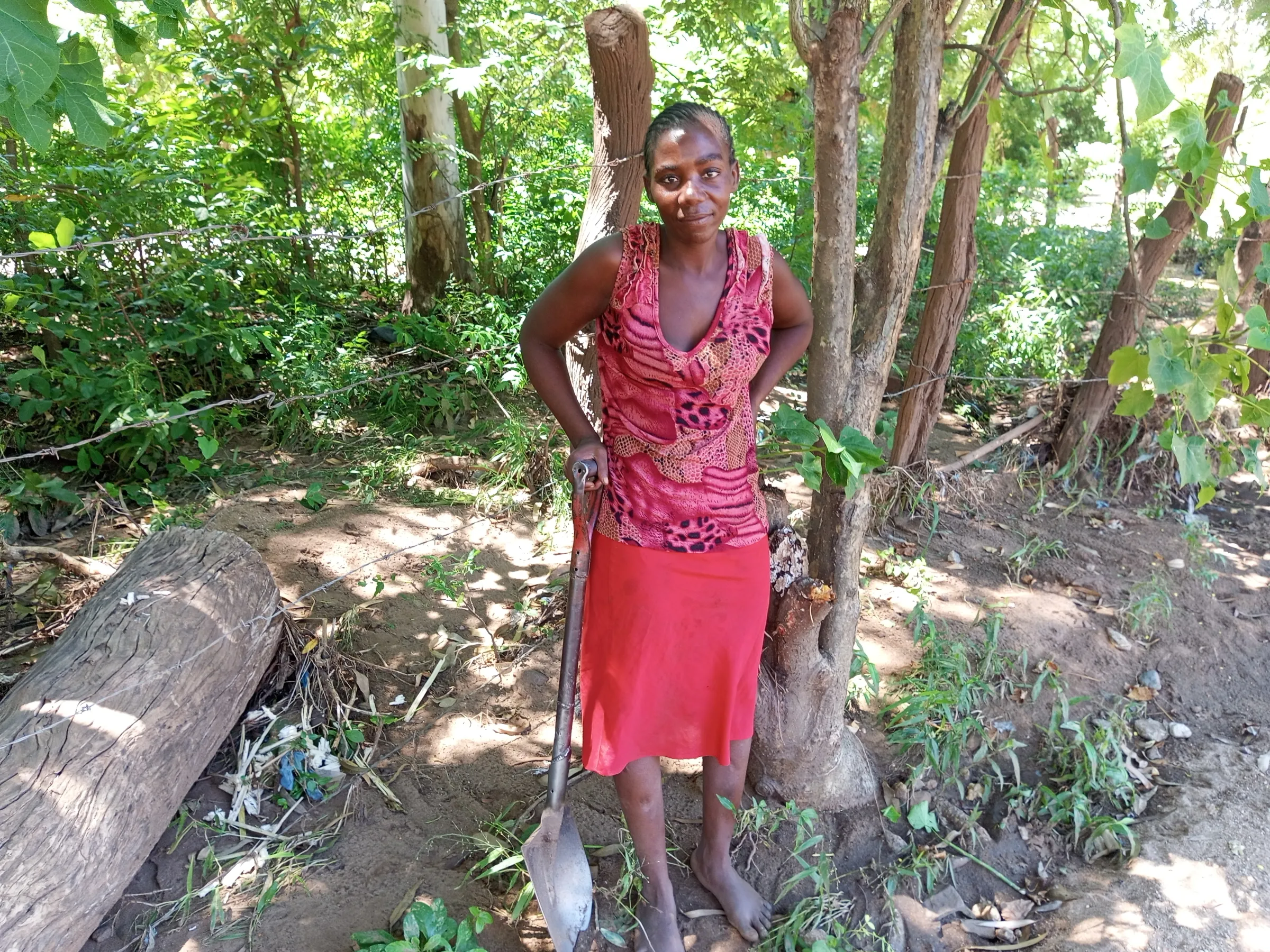 Mercy Richard, 32, a single mother-of-three collects sand from a roadside in Chikwawa district, southern Malawi, March 3, 2025. Thomson Reuters Foundation/Charles Pensulo