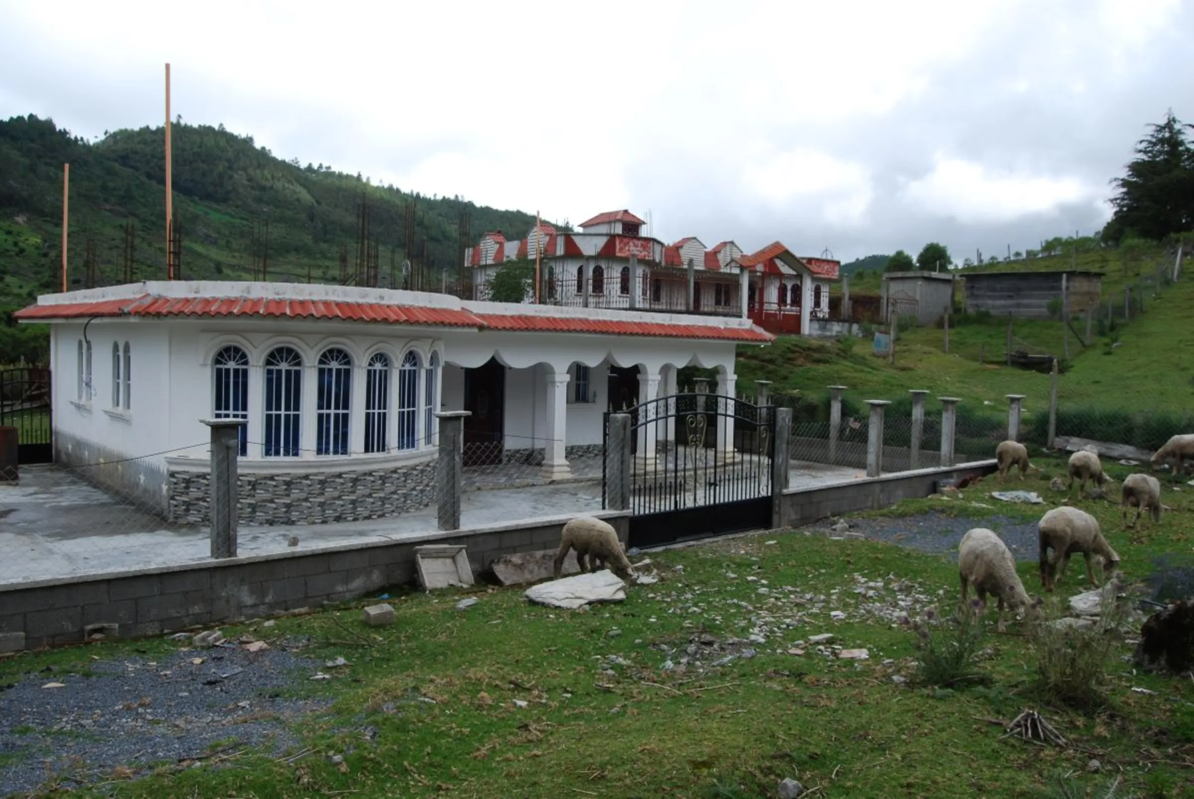 A house in the western highlands of Huehuetenango, Guatemala, built with dollars sent by relatives in the United States, September 4, 2023. Thomson Reuters Foundation/Anastasia Moloney