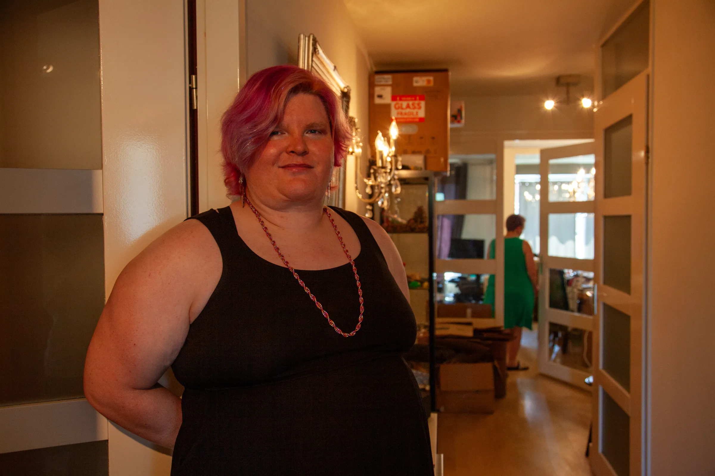 Lucy stands in the hallway of her new apartment in Amsterdam's De Pijp neighbourhood, which she shares with her partner, Alex. The two are still unpacking after their move, 12 July 2025. /Ingrid Gercama