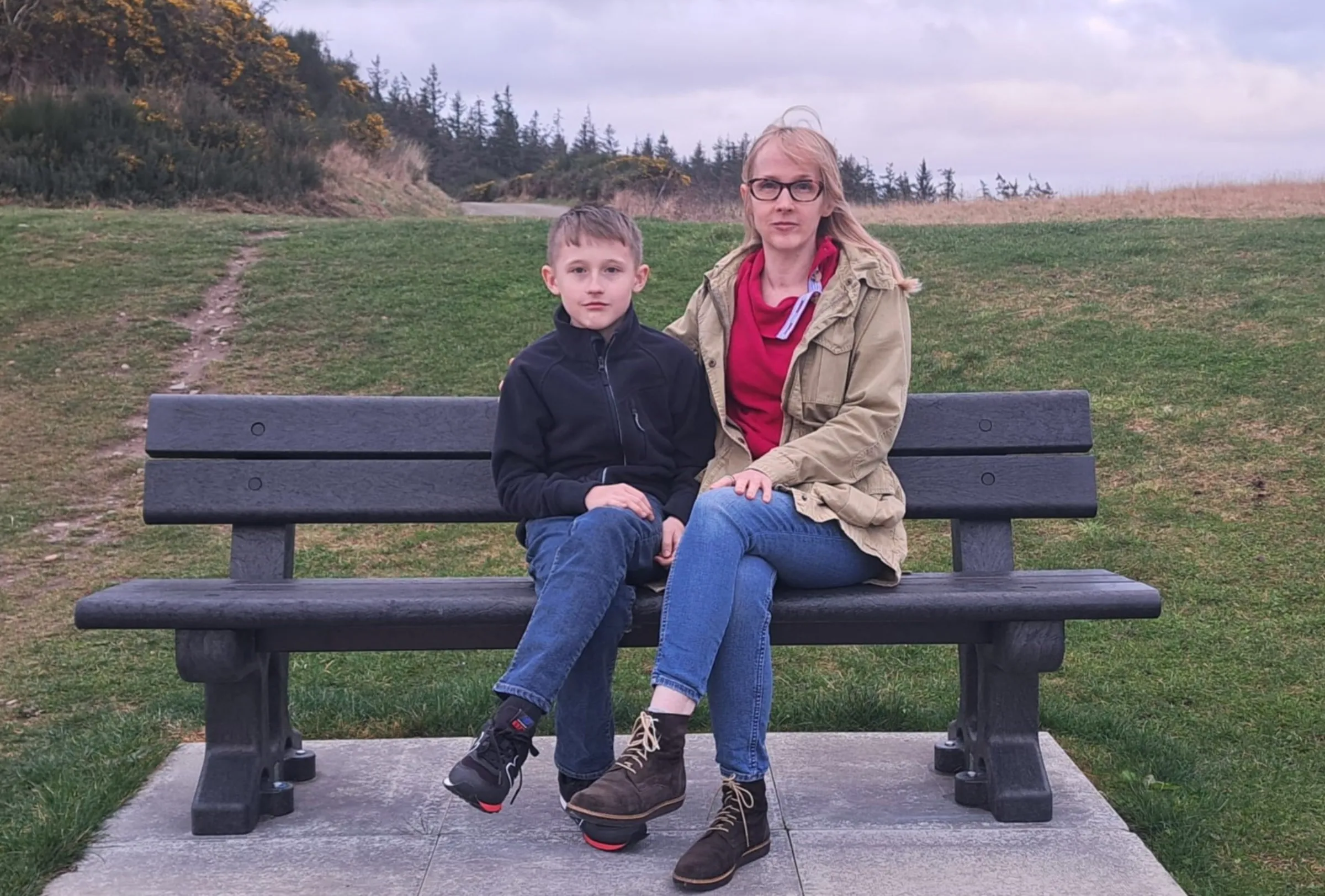 Fergus and Jennifer Robertson sit in a park near their home near Inverness, Scotland, in this photo taken March 10, 2025. Handout via Thomson Reuters Foundation