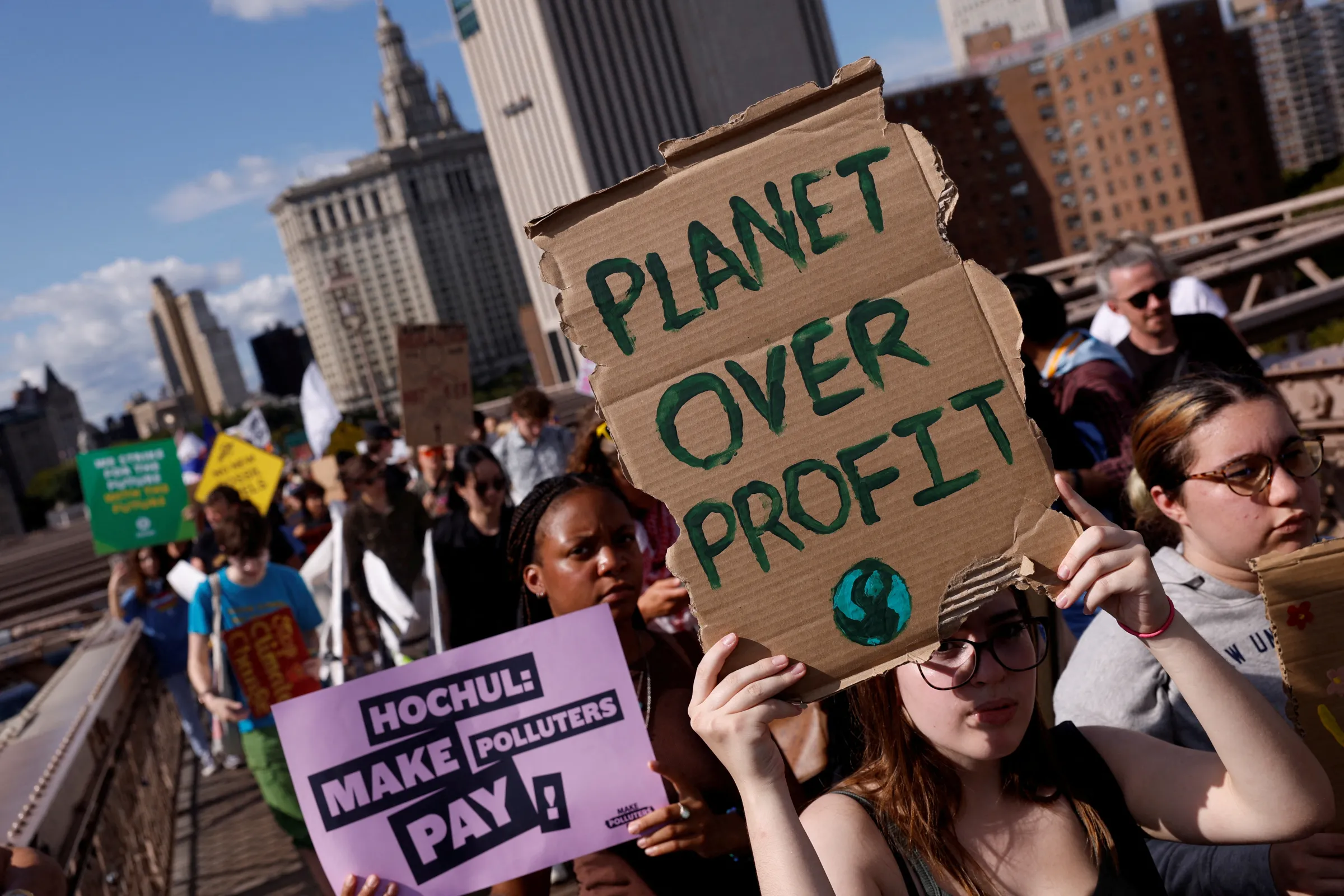 Demonstrators march across Brooklyn Bridge rallying to call to an end to the era of fossil fuels in New York City, U.S. September 20, 2024. REUTERS/Shannon Stapleton