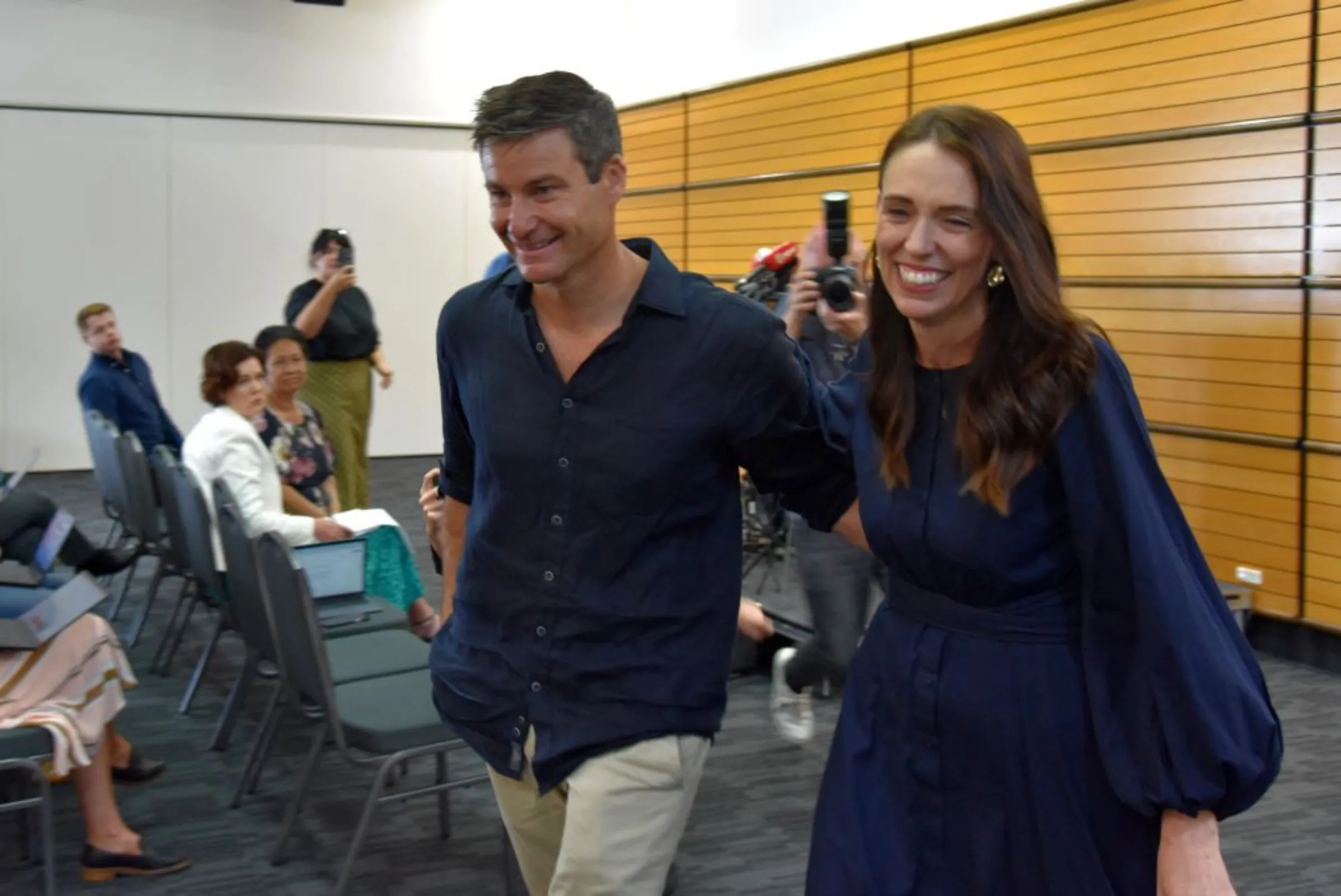 New Zealand Prime Minister Jacinda Ardern leaves with longtime partner Clarke Gayford following the announcement of her resignation at the War Memorial Hall, in Napier, New Zealand January 19, 2023. AAP Image/Ben McLay via REUTERS