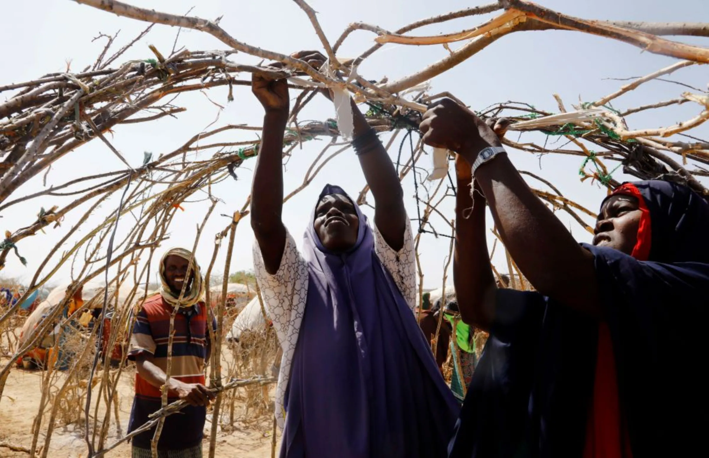 Somali women assemble a makeshift shelter within the Iftin Camp for the internally displaced people outside Baradere town, Gedo Region, Jubaland state, Somalia, March 13, 2022