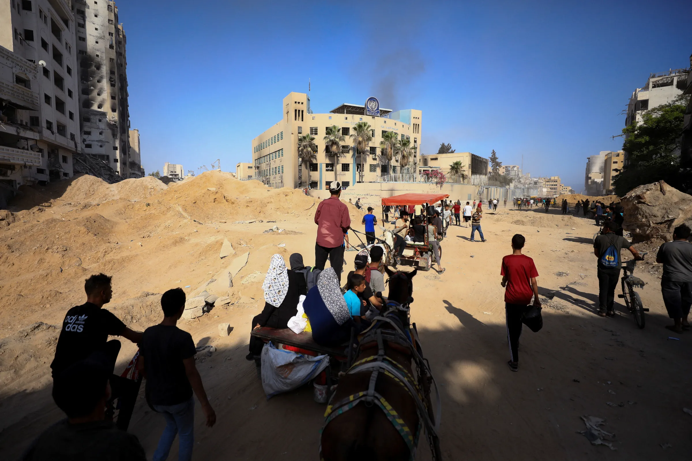 Palestinians gather to inspect the damages at the headquarters of UNRWA, following an Israeli raid, amid the Israel-Hamas conflict, in Gaza City, July 12, 2024. REUTERS/Dawoud Abu Alkas