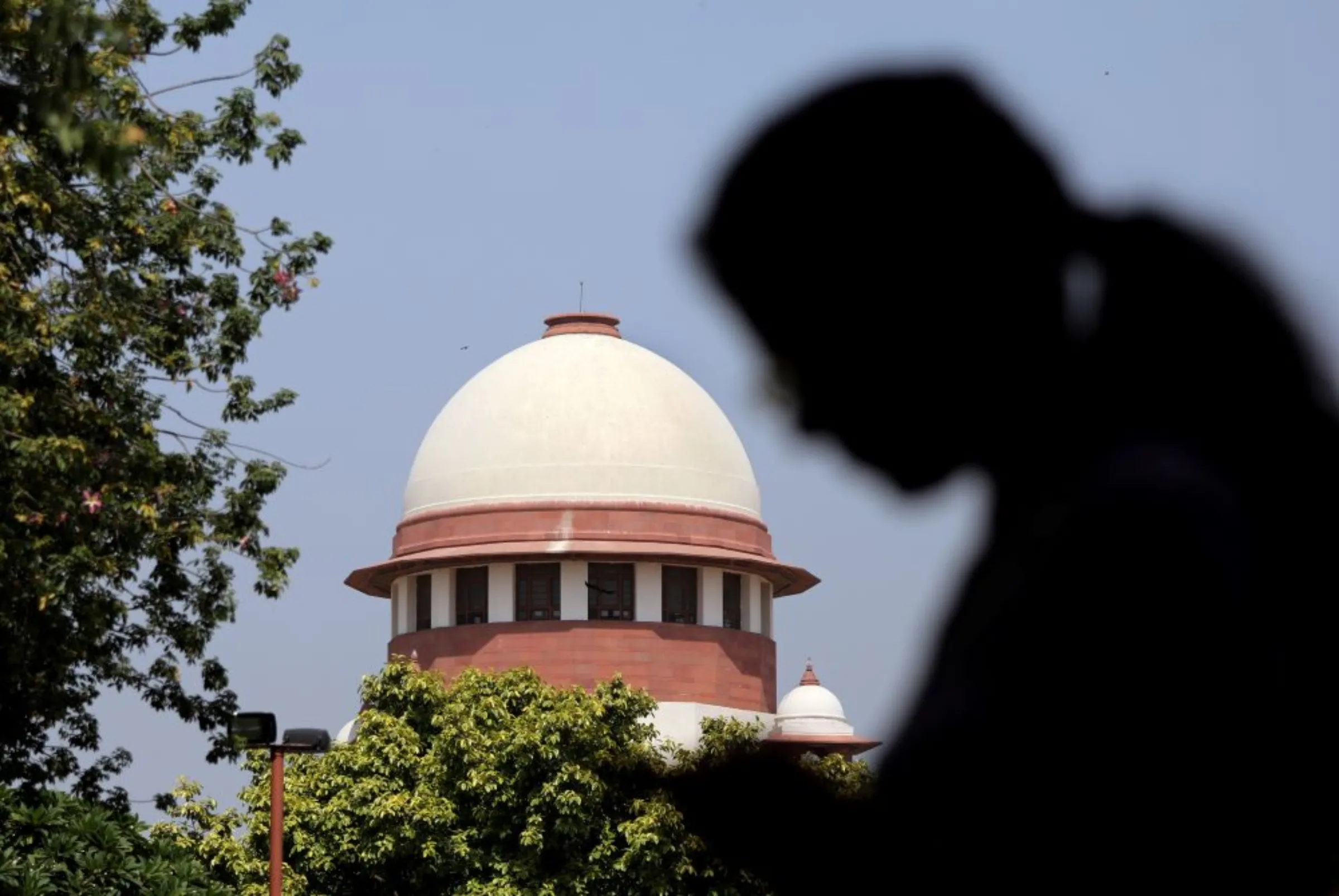 A woman checks her mobile phone inside the premises of the Supreme Court in New Delhi, India, September 28, 2018