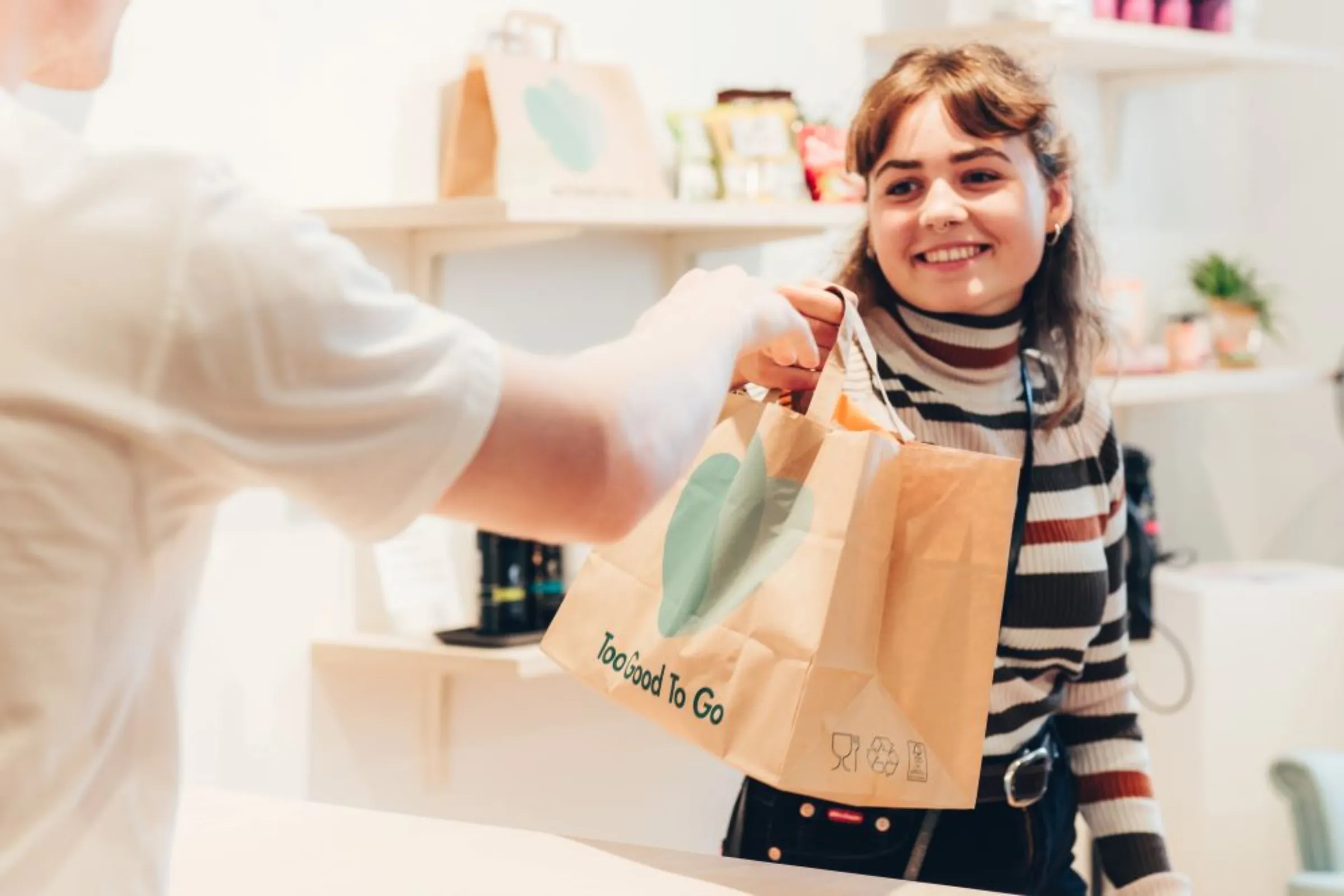 A customer receives a bag of food through the Too Good to Go app in Los Angeles. ‎November ‎30, ‎2022