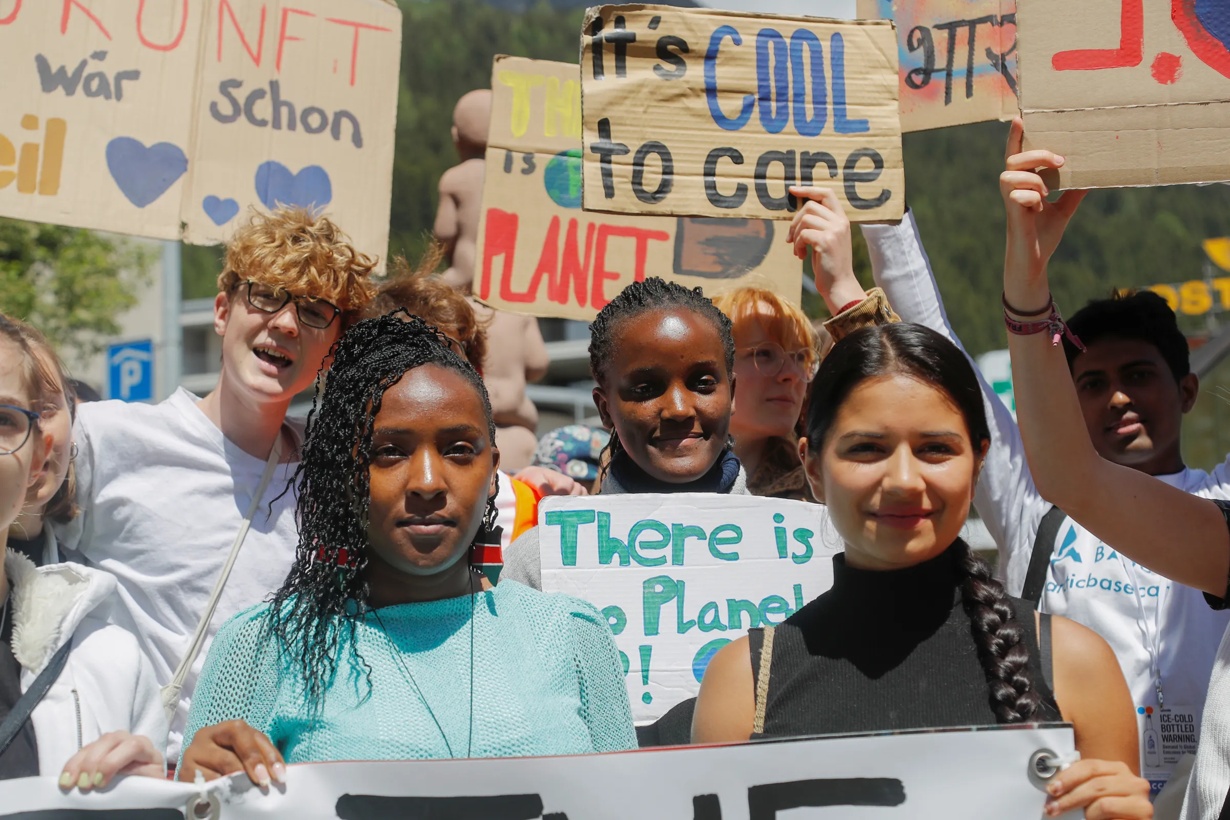 Climate activists Vanessa Nakate, Helena Gualinga and Elizabeth Wathuti hold signs, during a Fridays for Future climate strike on the last day of the World Economic Forum (WEF), in the alpine resort of Davos, Switzerland May 26, 2022. REUTERS/Arnd Wiegmann