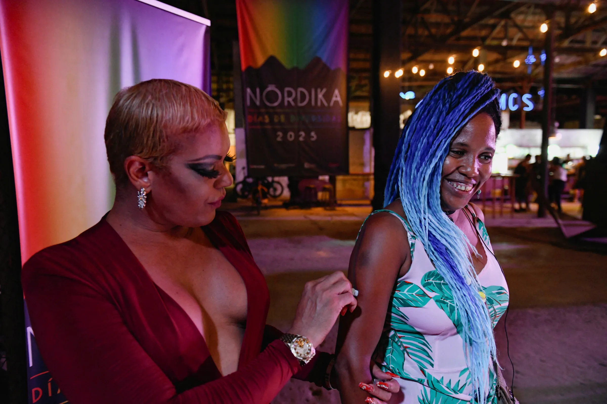 A transgender woman marks with the colors of the gay pride flag an attendee at the Nordika festival in Havana, Cuba May 24, 2025. REUTERS/Norlys Perez