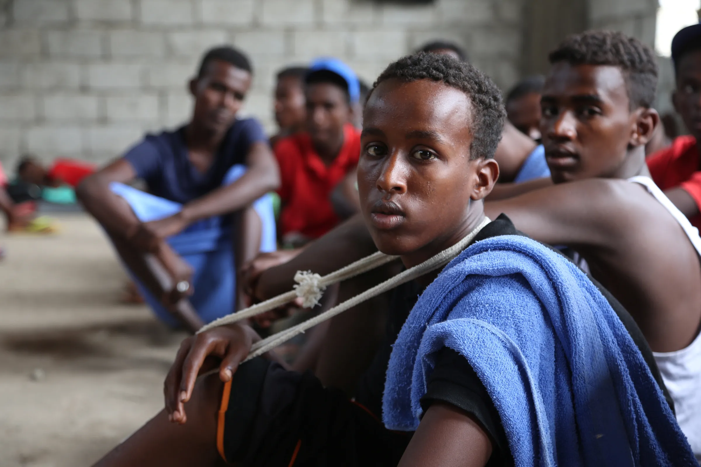 Somali refugees who survived an attack on a boat off Yemen's coast in the Red Sea sit at a detention center in the Houthi-held port of Hodeidah, Yemen, March 22, 2017. REUTERS/Abduljabbar Zeyad