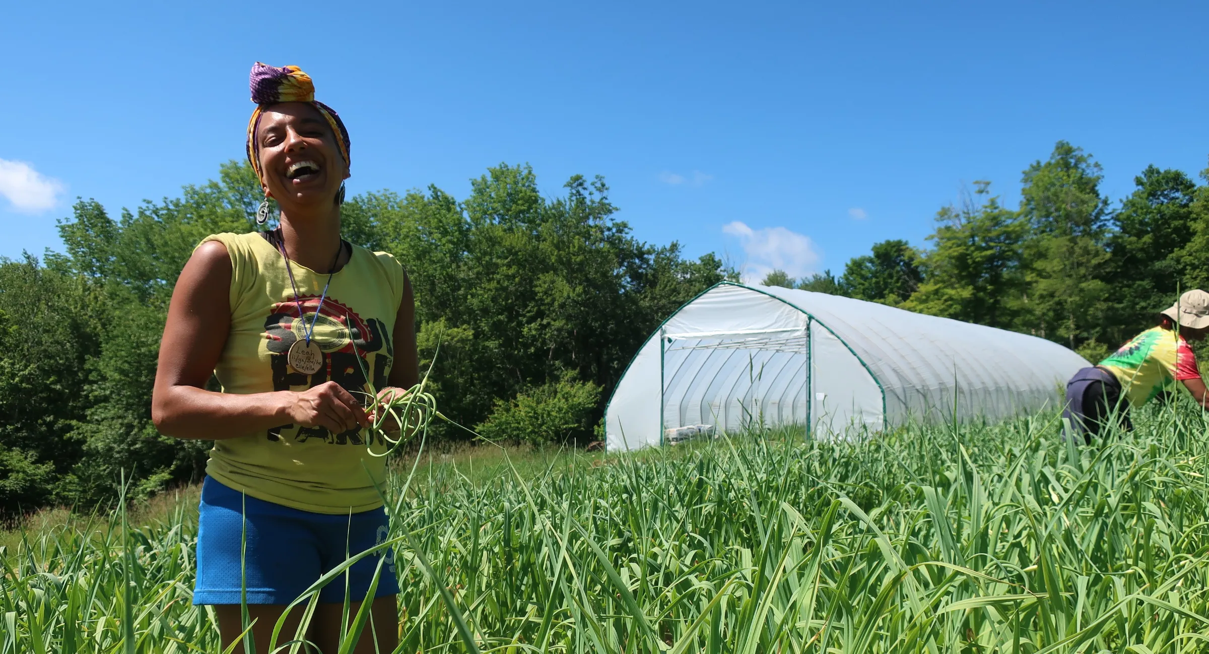 A farmer laughs on a farm in New York. Photo courtesy of Soul Fire Farm.