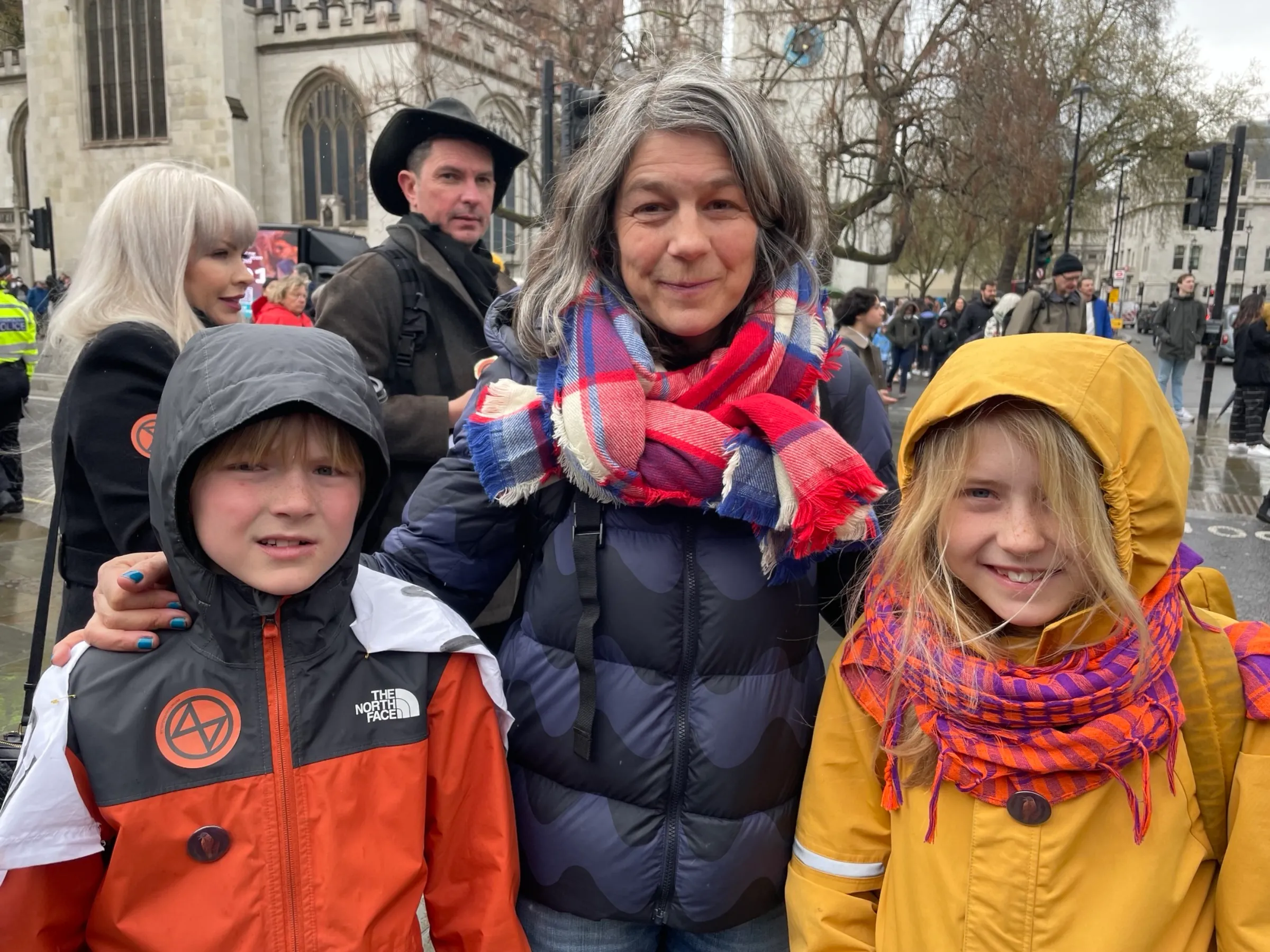 Family members Stanley, Zoe and Bella Kavanagh join “The Big One”, a protest organised by Extinction Rebellion outside Parliament in London on April 21, 2023. Thomson Reuters Foundation/Laurie Goering