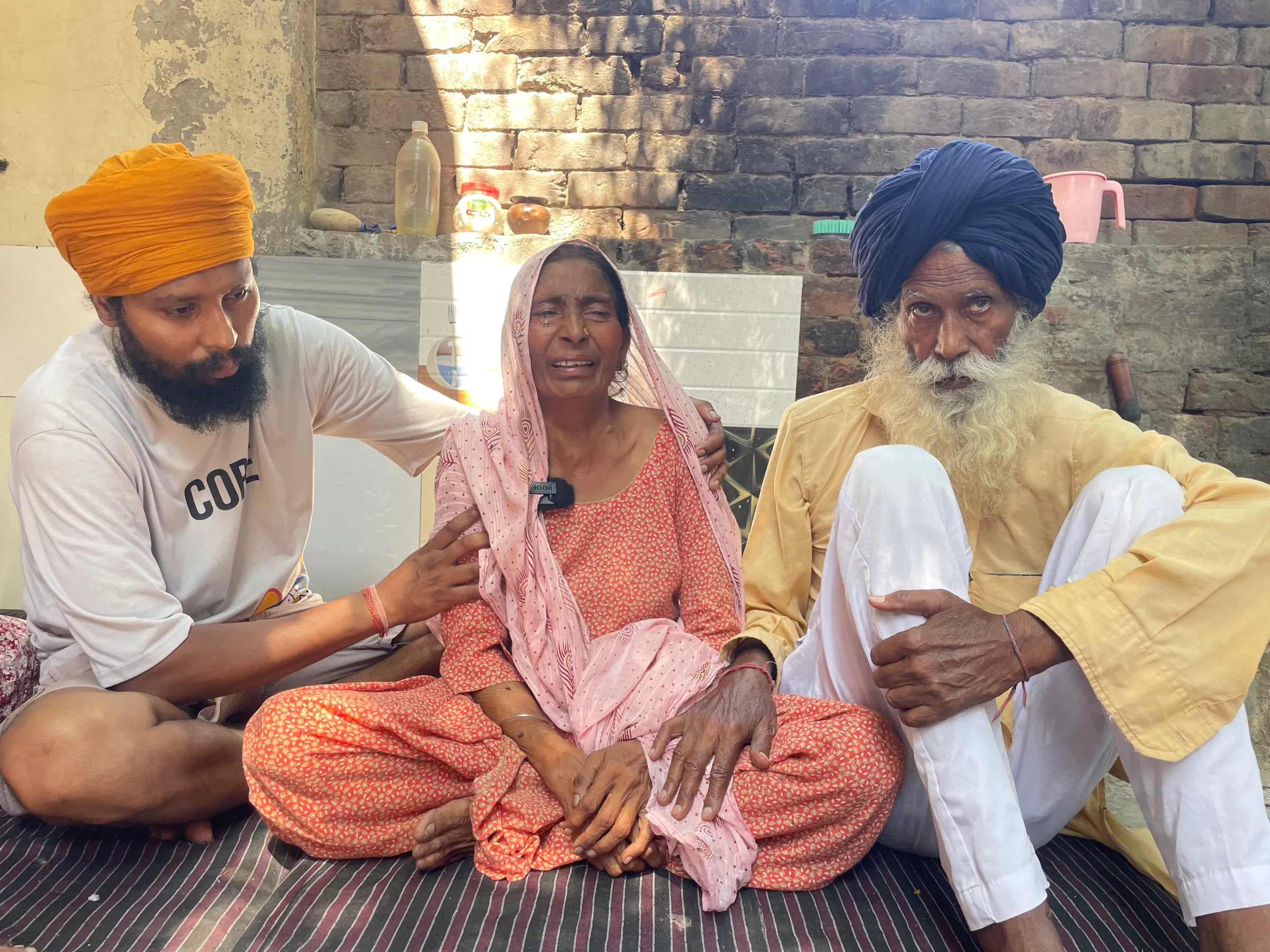 The brother (L), mother (C) and father (R) of Satnam Singh, a labourer who died from an accident on a farm in Italy, mourn after his funeral in Chand Nawan village of Punjab, India, September 24, 2024. Thomson Reuters Foundation/Sandeep Singh