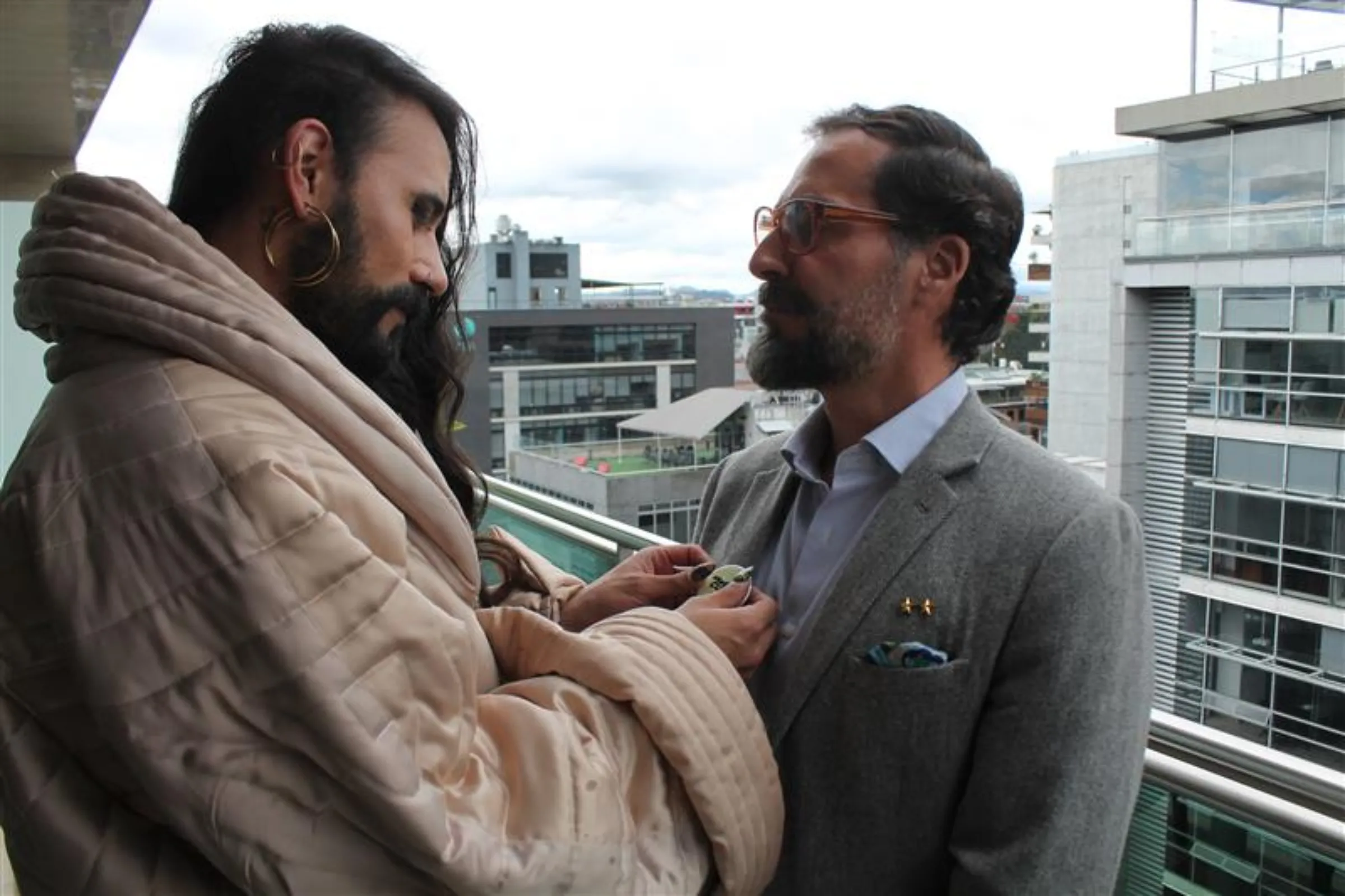 Colombian trans activist Danne Belmont puts a pin that reads 'Nada que curar' (nothing to heal, in Spanish) on the jacket of Juan Viana, a gay man who underwent so-called 'conversion therapy' as a teenager in Bogotá, on July 24, 2025. Thomson Reuters Foundation/Enrique Anarte