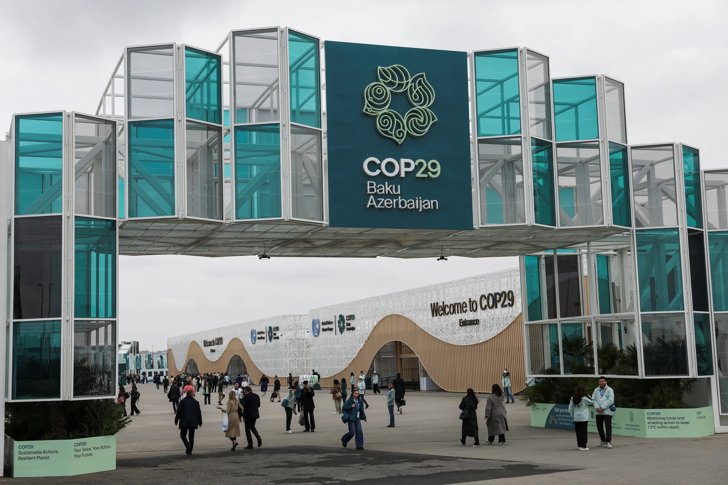 People walk at the entrance of the venue of the United Nations climate change conference COP29, in Baku, Azerbaijan November 11, 2024. REUTERS/Murad Sezer