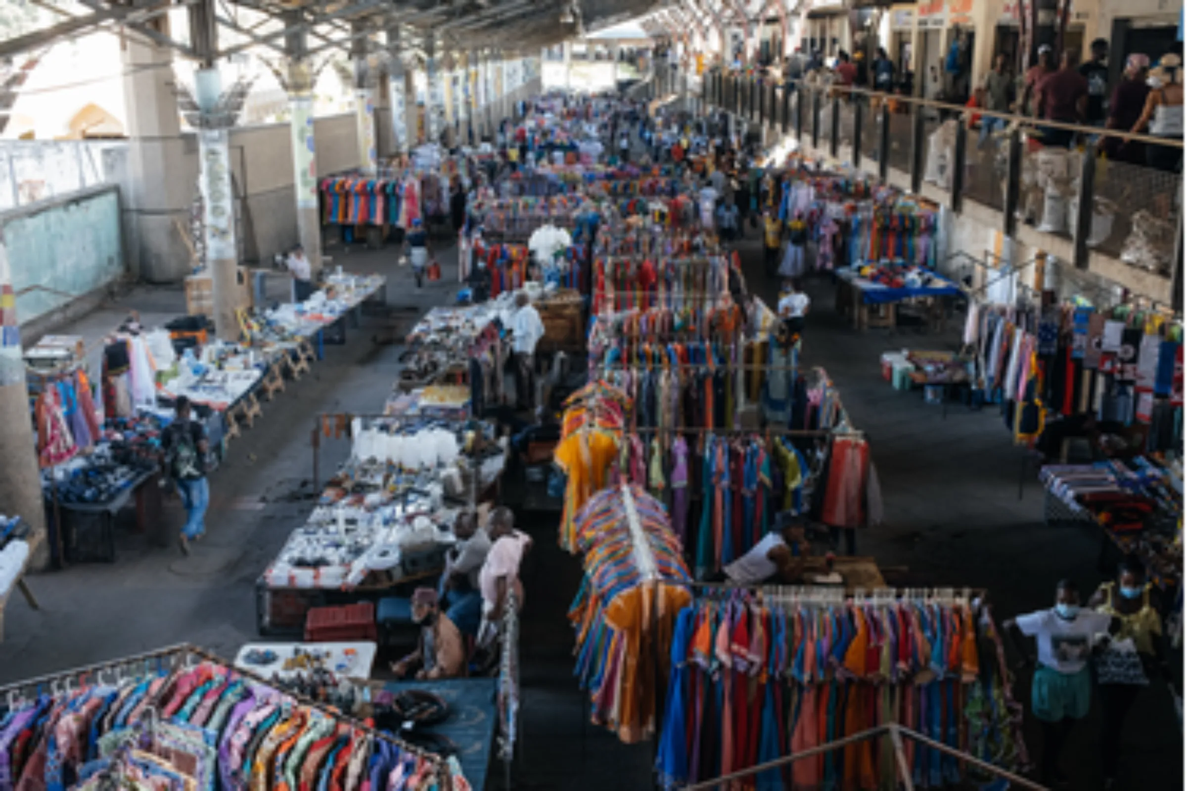 Potential buyers look at the wares at Warwick Market in inner-city Durban, South Africa March 31, 2021. Informal traders at the busy market offer everything from fresh produce and traditional medicine to clothes and music. Thomson Reuters Foundation/James Puttick.
