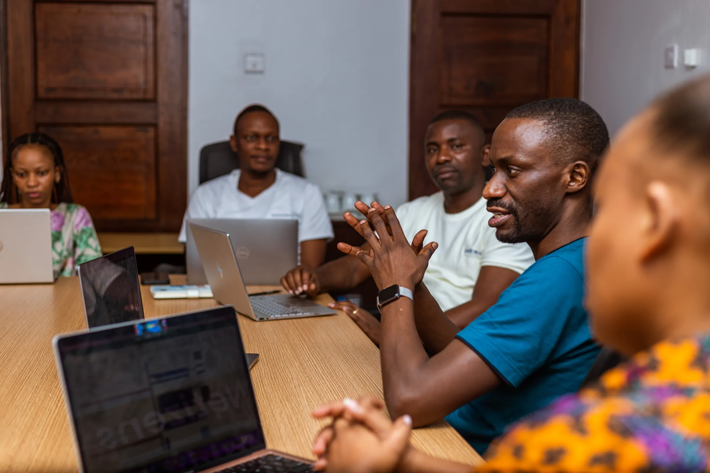 Maxence Melo, founder of JamiiForums, talks to his colleagues during a meeting at their office in Dar es Salaam, Tanzania. May 27, 2022. Thomson Reuters Foundation/ Yohana Haule