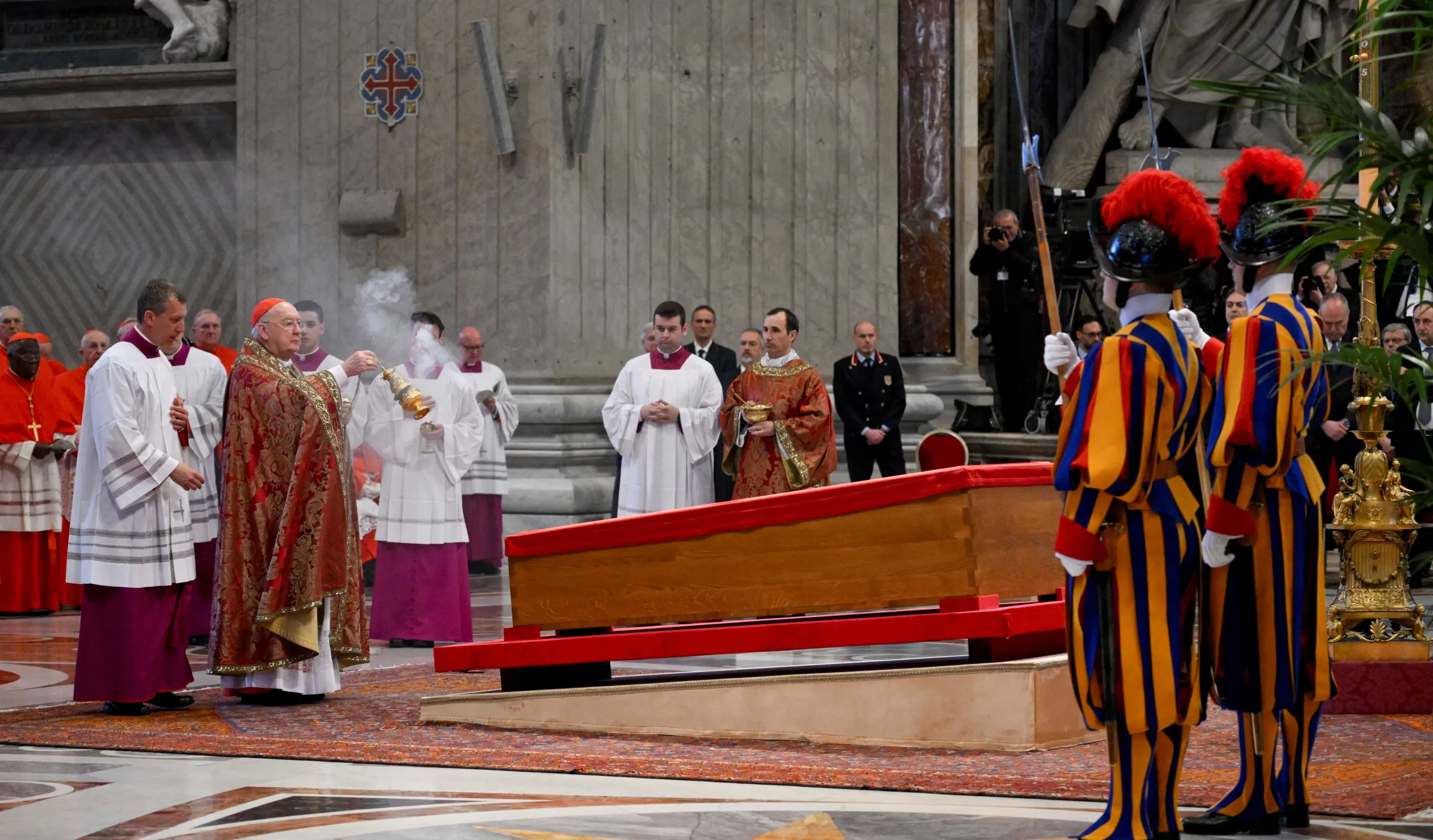 Cardinal Camerlengo Kevin Joseph Farrell swings a thurible of incense as Pope Francis's body rests inside his coffin, on the day of the translation of his body, in St. Peter's Basilica at the Vatican, April 23, 2025. Vatican Media/­Handout via REUTERS