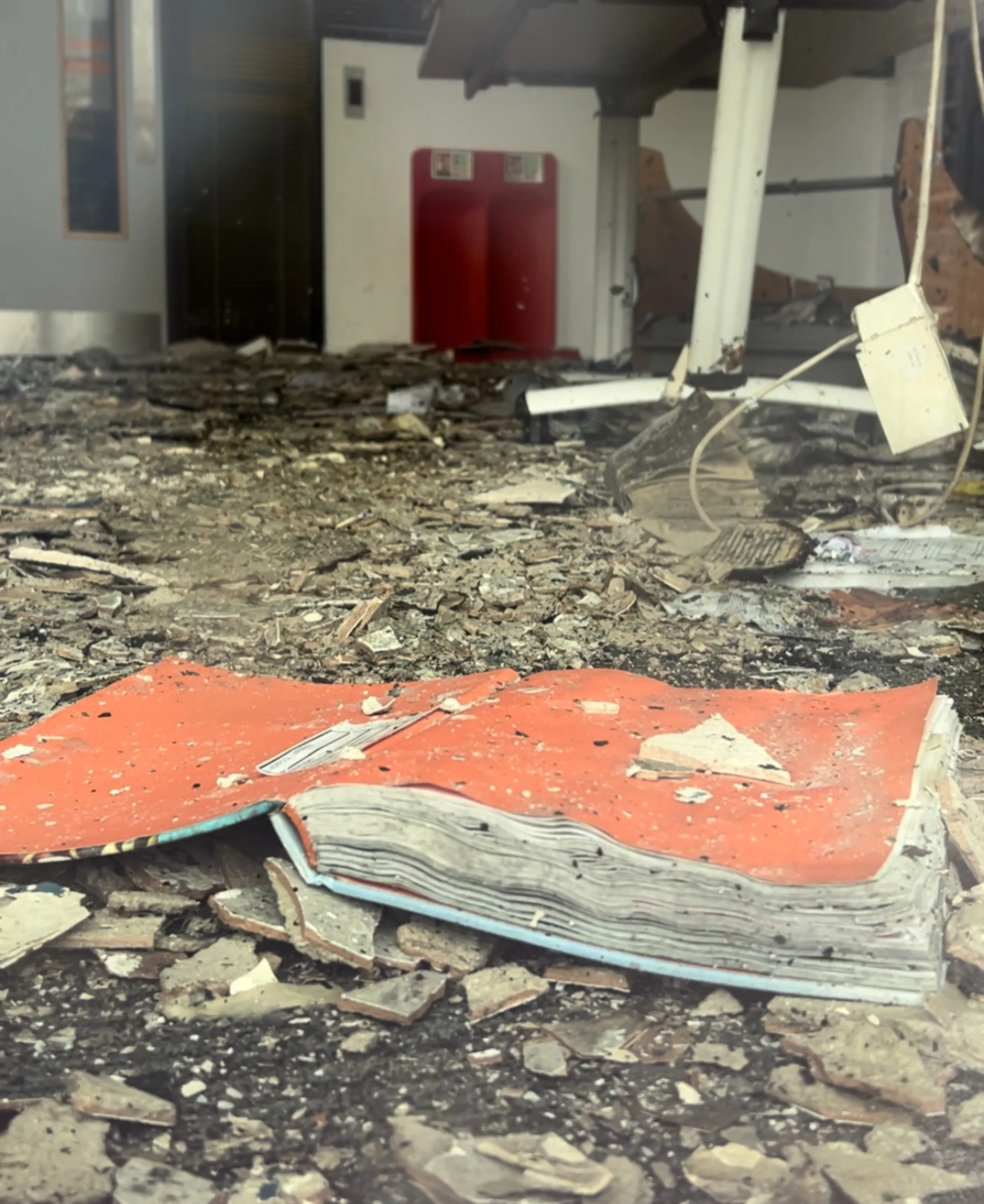 An open book can be seen lying among rubble on the ground floor of Spellow Lane Library Hub in Walton, Liverpool, after it was targeted by rioters in the city. August 5, 2024. Thomson Reuters Foundation/Lucy Middleton