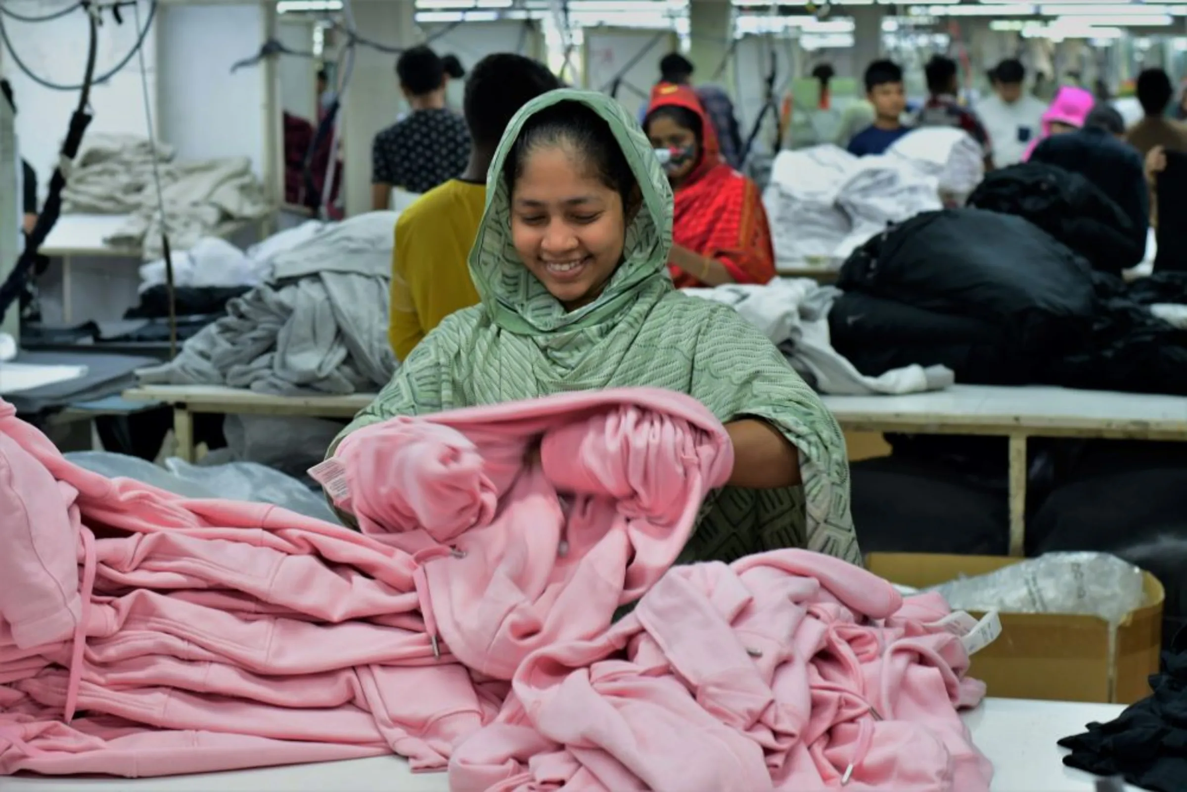 Worker Tanzila Begum checks the quality of clothing produced at the Plummy Fashions factory at North Narayanganj, Bangladesh, January 31, 2023