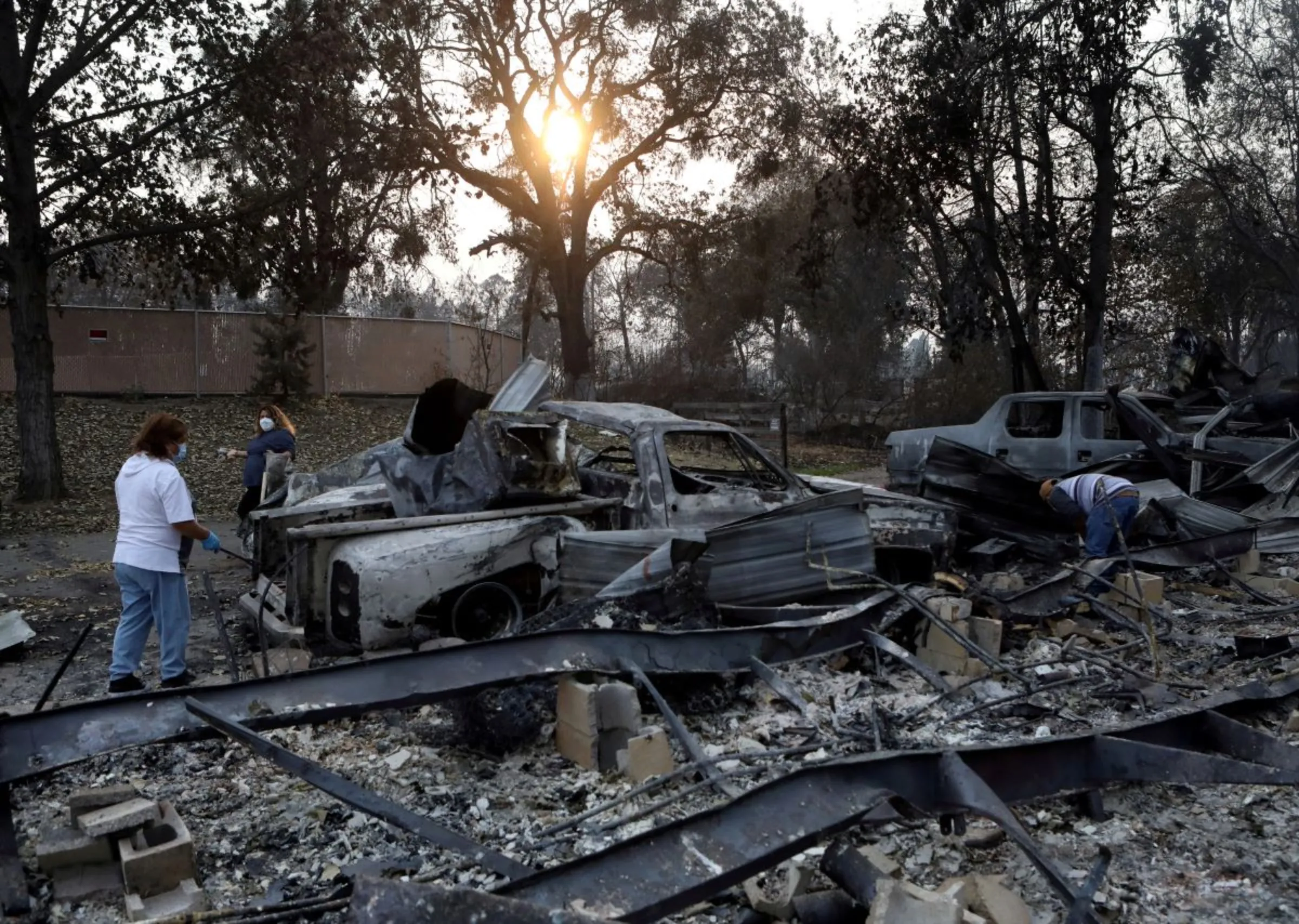 Residents search for items to salvage in the remains of their burned home, which was destroyed by a wildfire in Phoenix, Oregon, U.S. September 22, 2020. REUTERS/Jim Urquhart