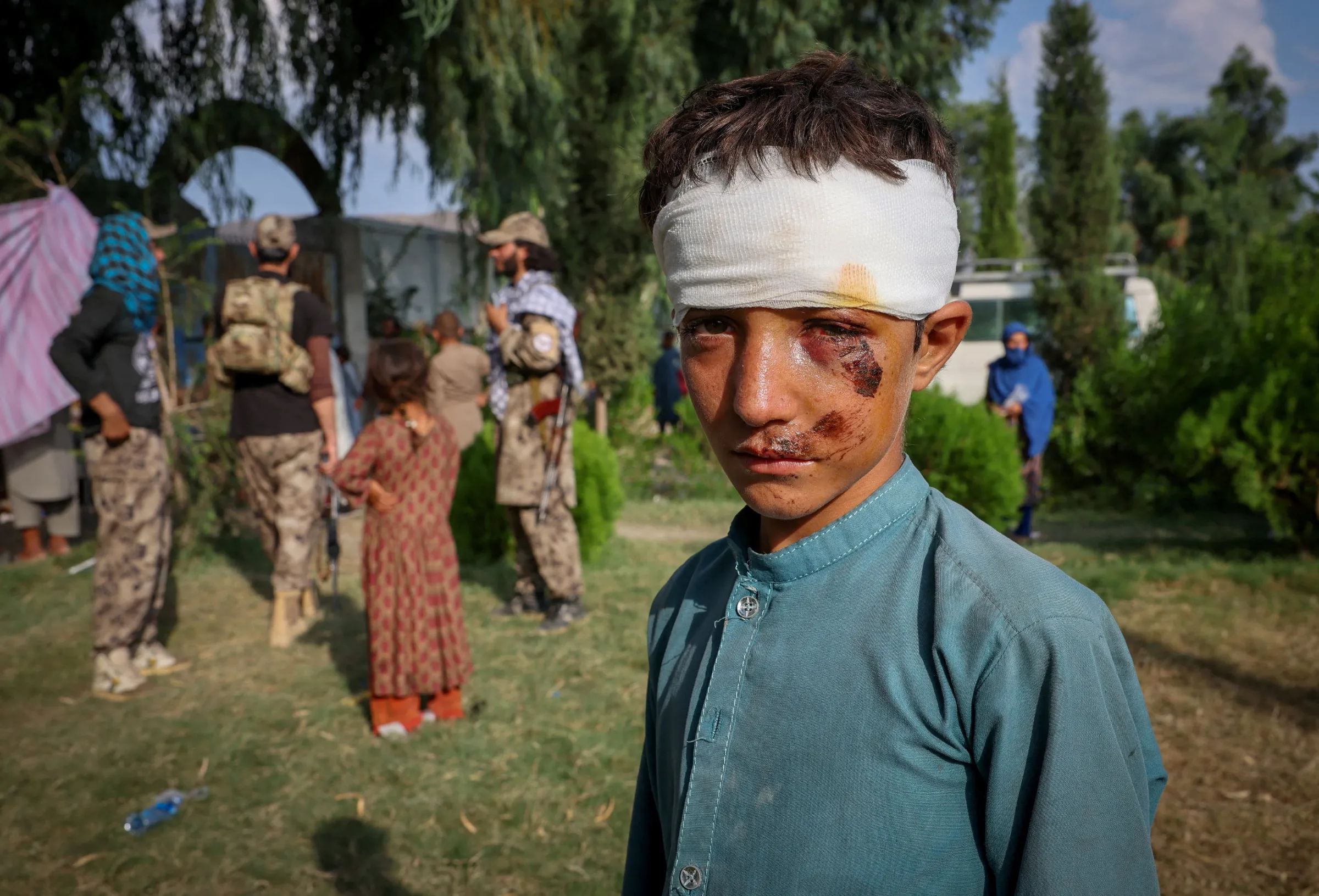 A boy waits after getting treatment at a mobile clinic setup inside a school, in Nurgal district, Kunar province, Afghanistan, September 3, 2025. REUTERS/Sayed Hassib