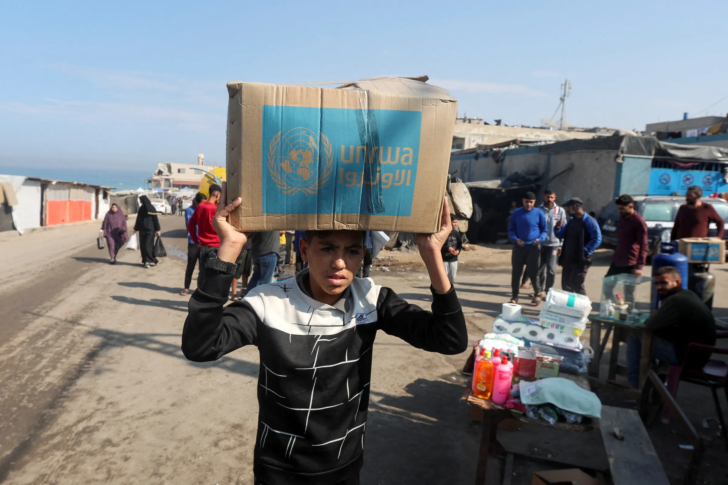 A Palestinian carries an aid box distributed by the United Nations Relief and Works Agency (UNRWA), amid the Israel-Hamas conflict, in Deir Al-Balah, central Gaza Strip, November 4, 2024. REUTERS/Ramadan Abed