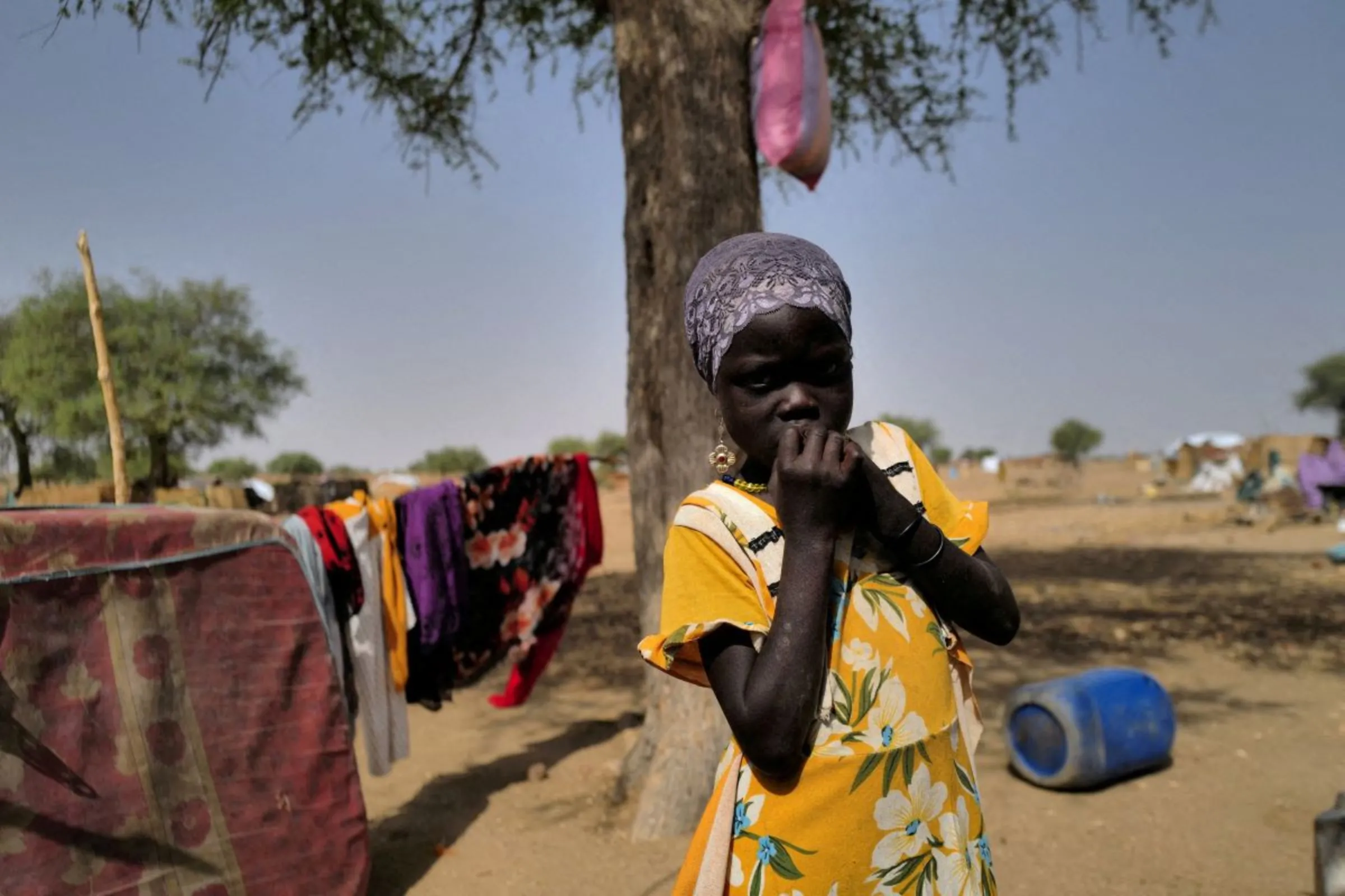 A Sudanese refugee who has fled the violence in Sudan's Darfur region, looks on as she stands by her shelter, near the border between Sudan and Chad in Koufroun, Chad May 15, 2023