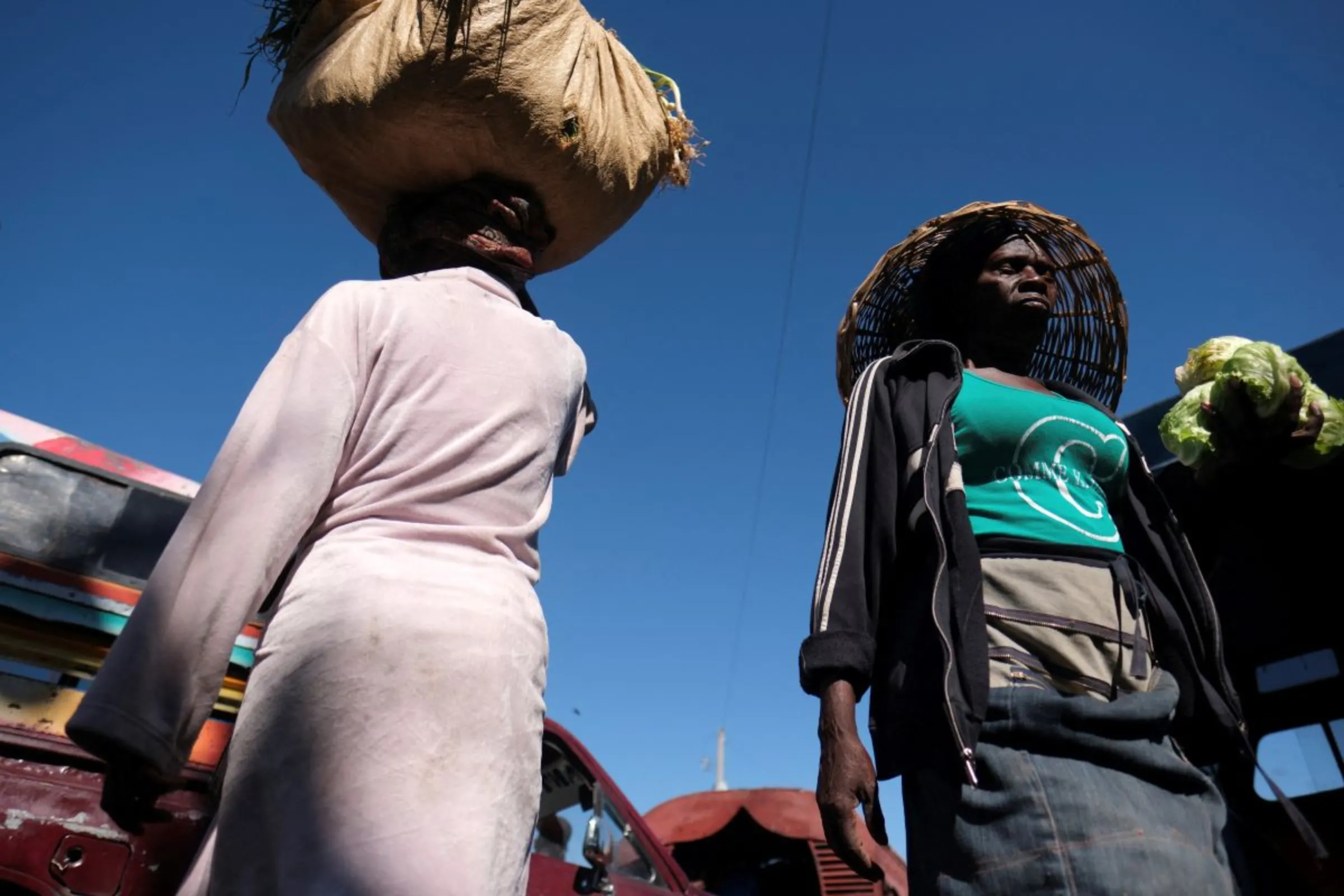 Women sell their fresh product at a Tap Tap transport station days after Haiti police blocked streets and broke into the airport during a protest demanding justice for fellow police officers killed by armed gangs, in Port-au-Prince, Haiti February 1,2023. REUTERS/Ricardo Arduengo