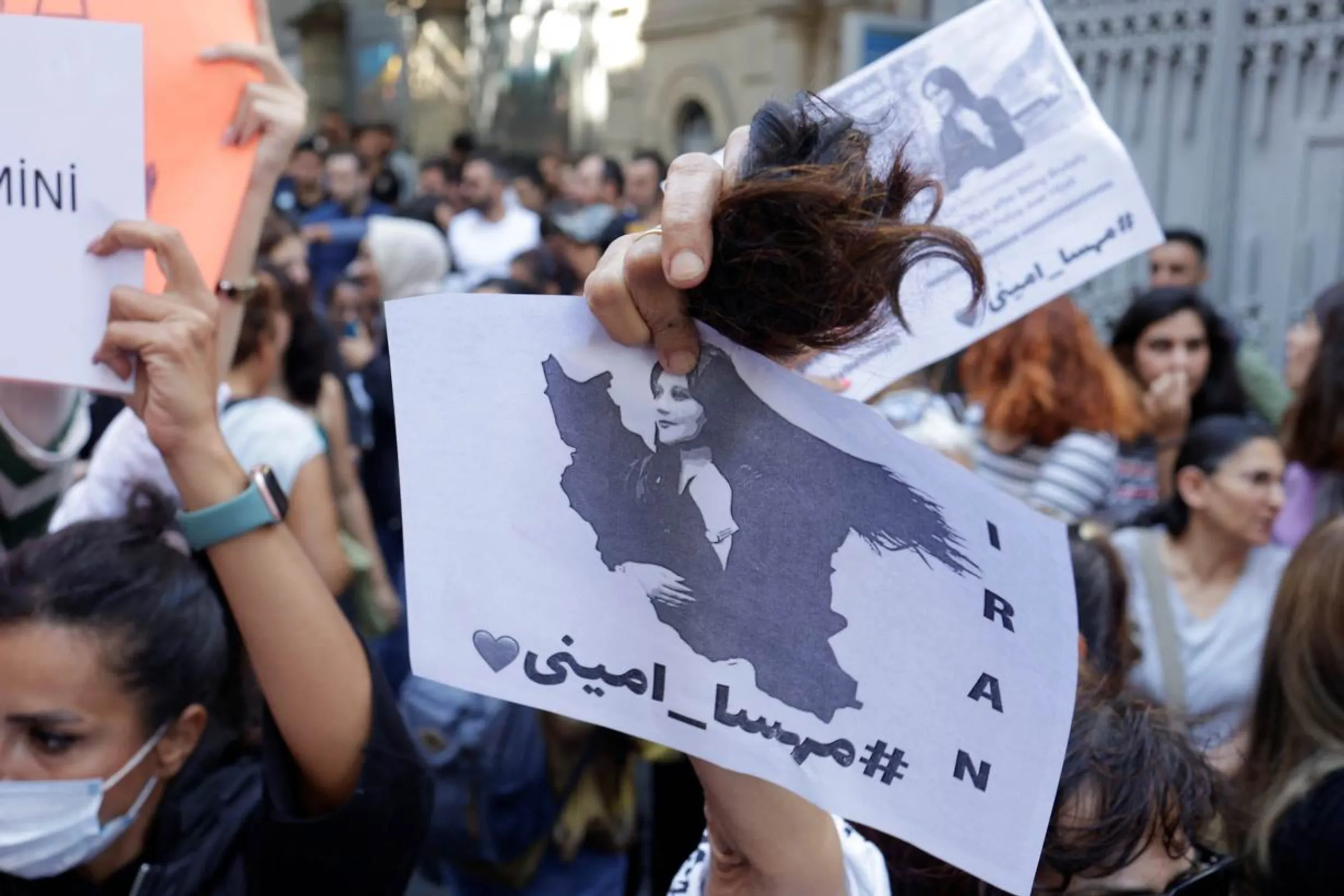 A demonstrator holds cut hair during a protest following the death of Mahsa Amini, outside the Iranian consulate in Istanbul, Turkey September 21, 2022