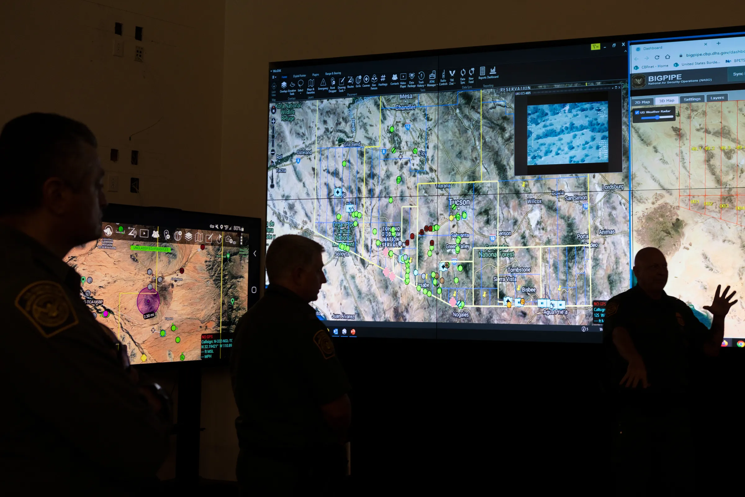 Agents stand in front of maps displaying surveillance infrastructure at U.S. Border Patrol Tucson Sector Headquarters on Davis Monthan Air Force Base in Tucson, Arizona, U.S., August 31, 2022
