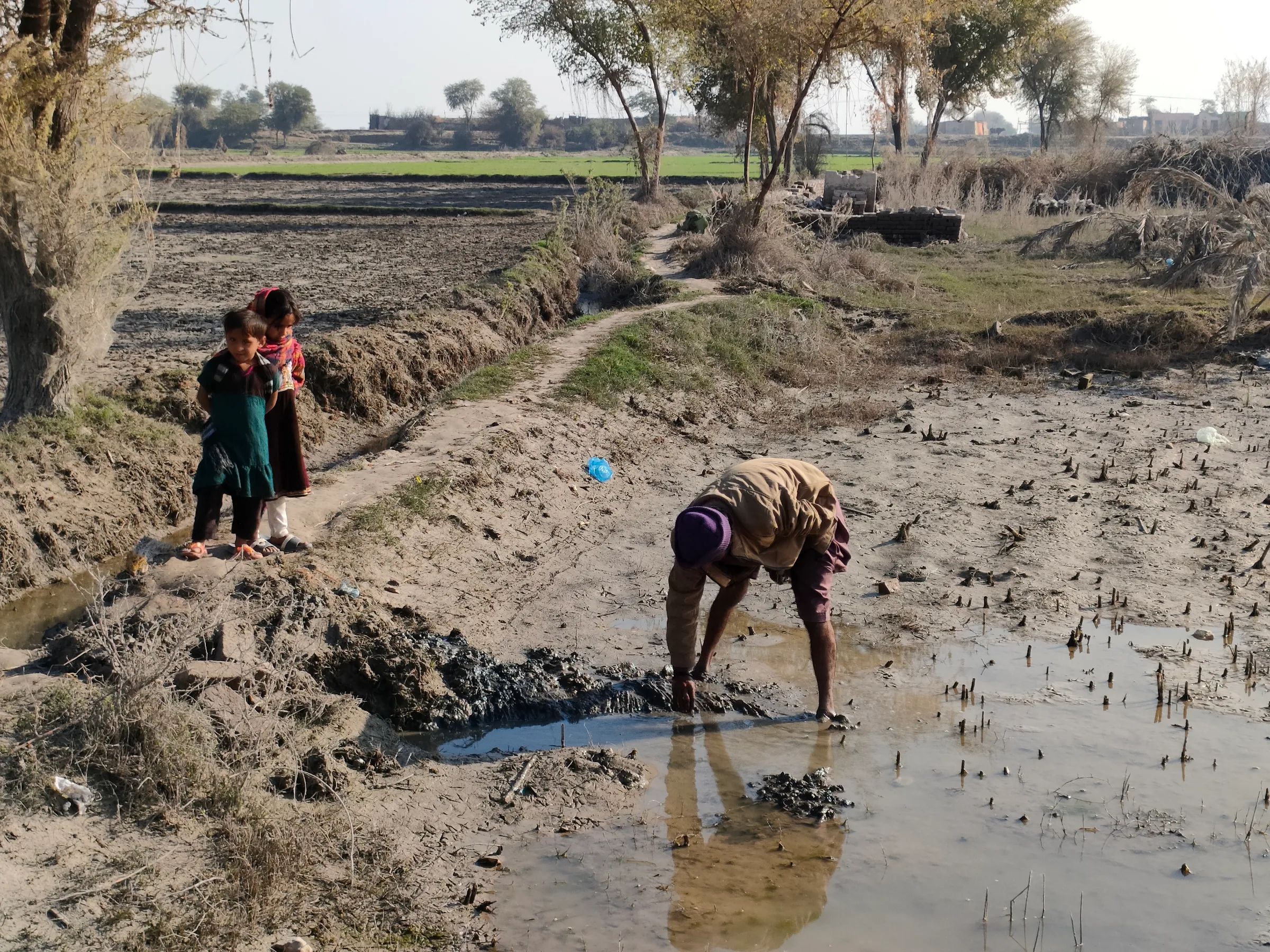 A villager dewaters his fields in the flood-hit village Gozo, Pakistan January 17, 2023. Thomson Reuters Foundation/Waqar Mustafa