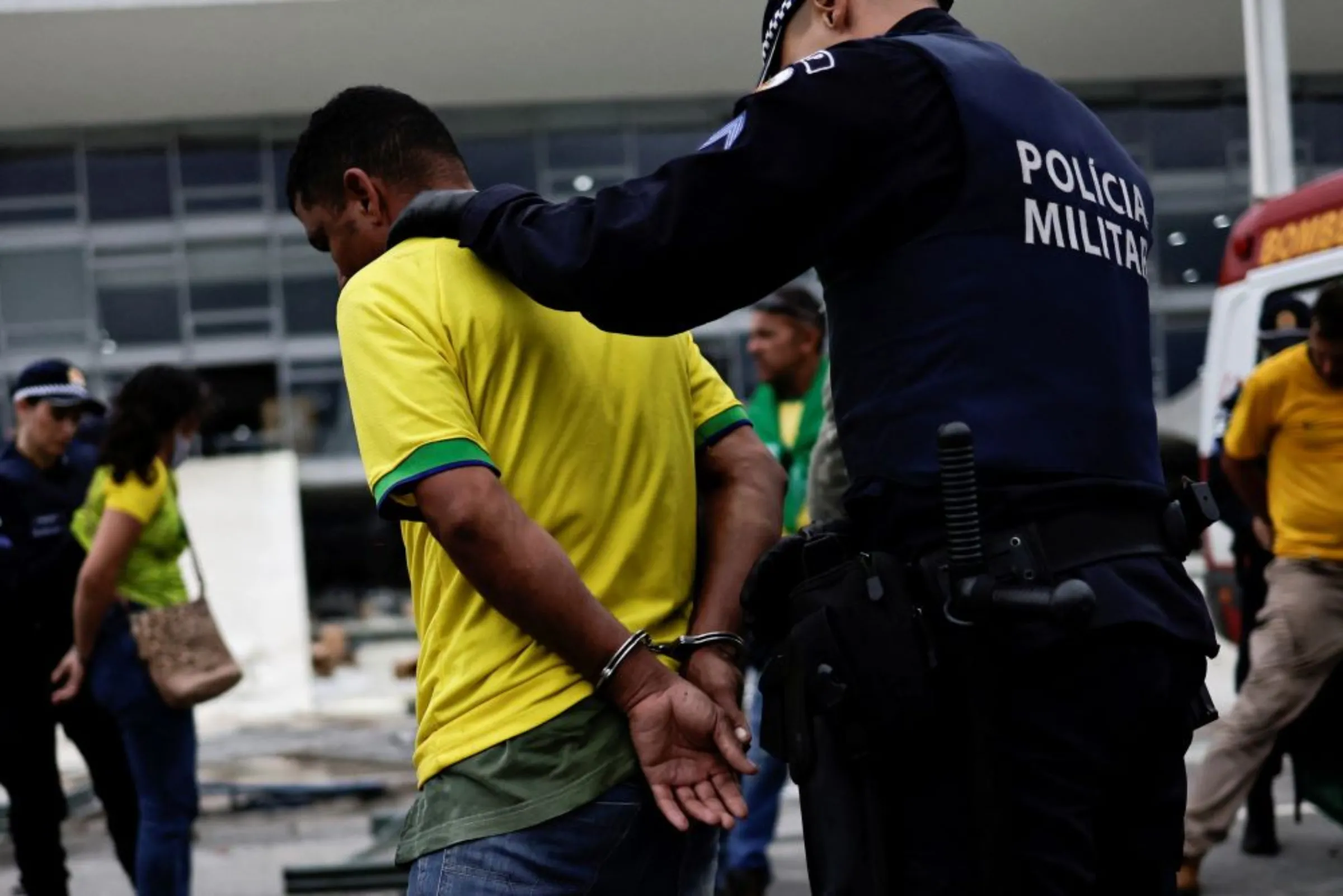 A supporter of Brazil's former President Jair Bolsonaro is detained during a demonstration against President Luiz Inacio Lula da Silva, outside Planalto Palace in Brasilia, Brazil, January 8, 2023. REUTERS/Ueslei Marcelino