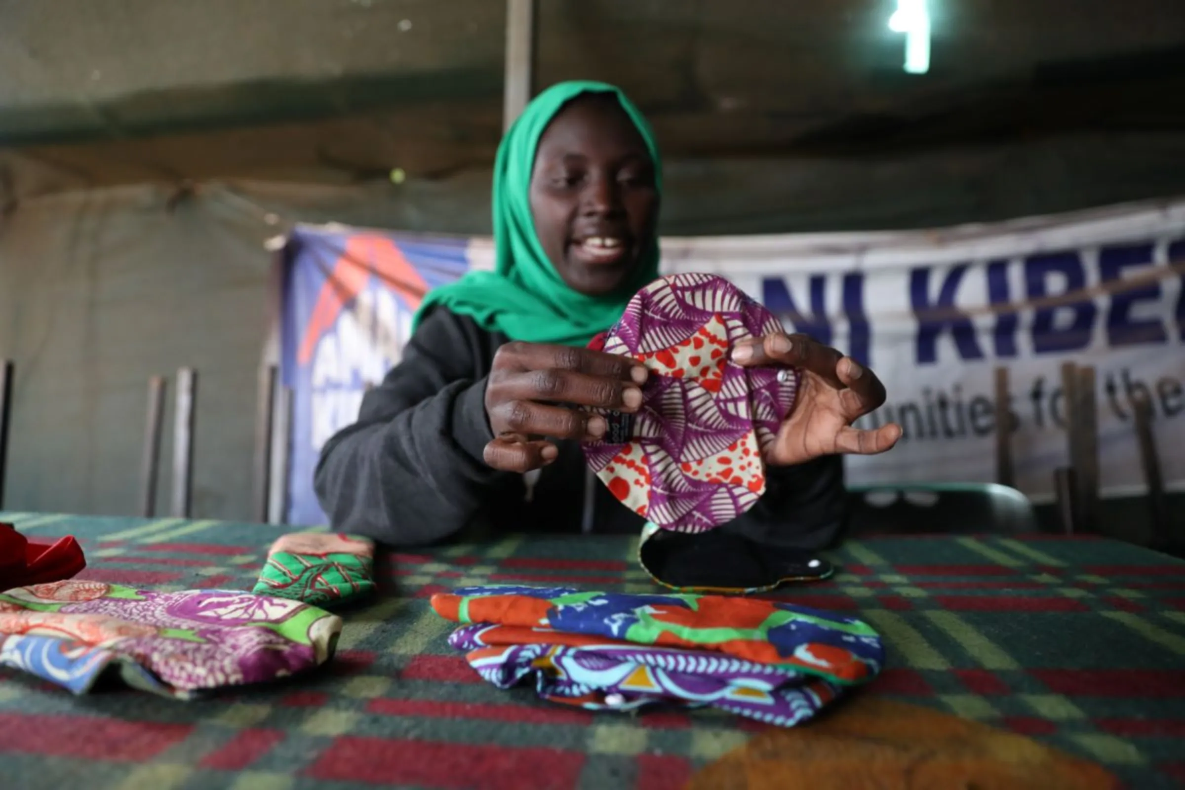 Mariam Twahir, co-founder of charity Amani Kibera shows the reusable pads being made and distributed to girls in Kibera informal settlement in Nairobi, Kenya on April 15, 2023