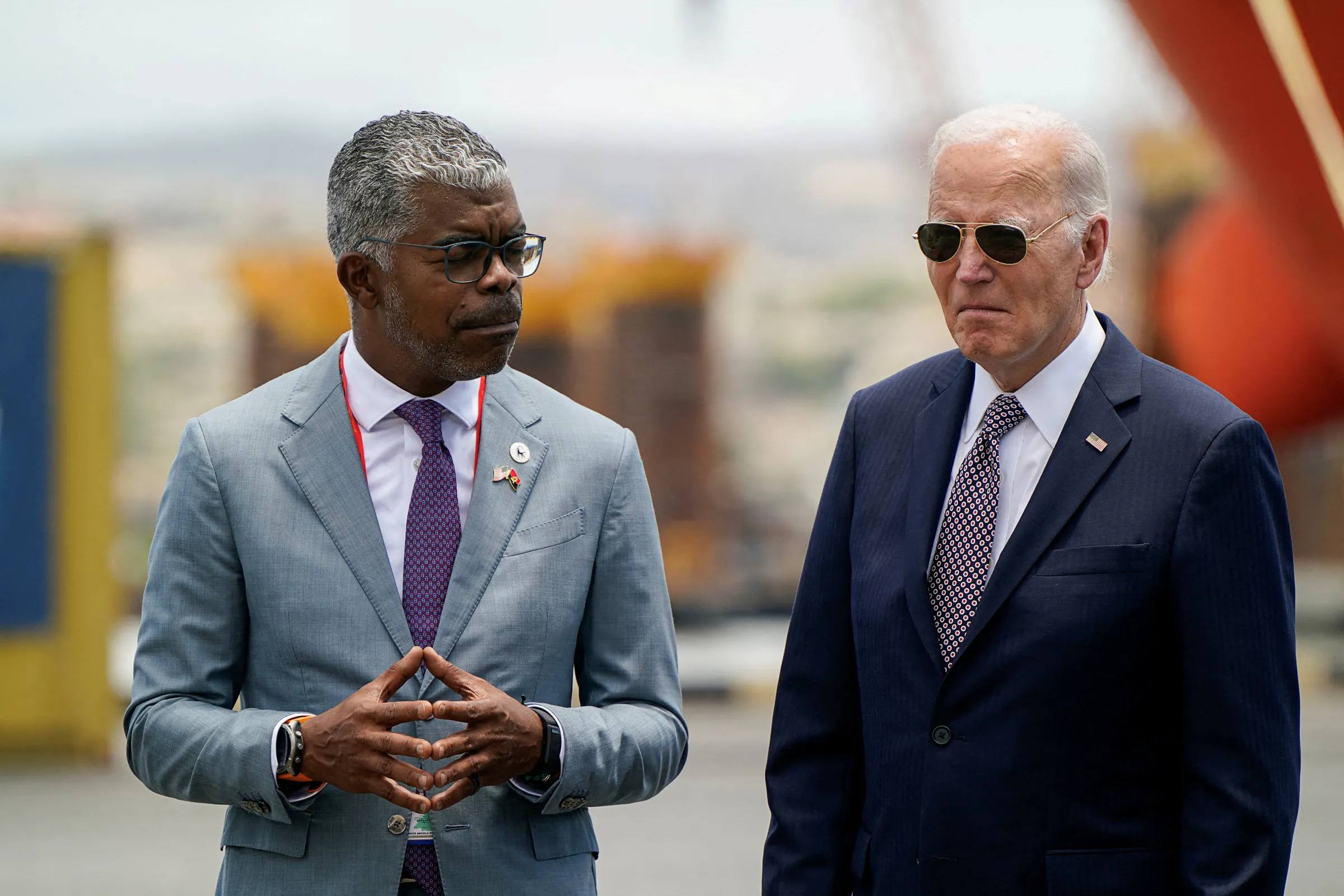 U.S. President Joe Biden stands with Angolan Minister of Transport Ricardo Daniel Sandao Queiros Viegas de Abreu, during a visit to the Lobito Port Terminal in Lobito, Angola, December 4, 2024. REUTERS/Elizabeth Frantz