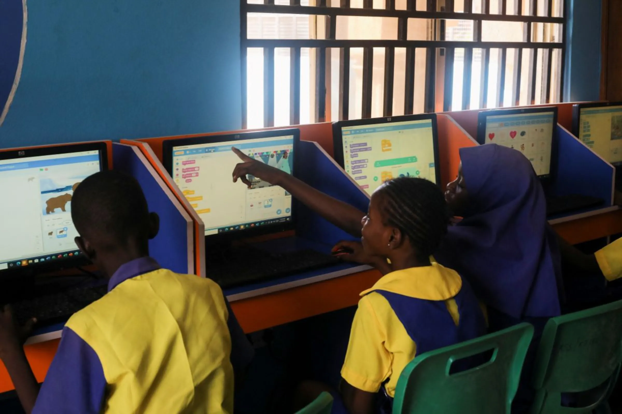 A student enrolled in a special STEM programme for children from poor families at the Knosk Secondary School, attend a computer class alongside other students in the area of Kuje, in Abuja, Nigeria February 18, 2022